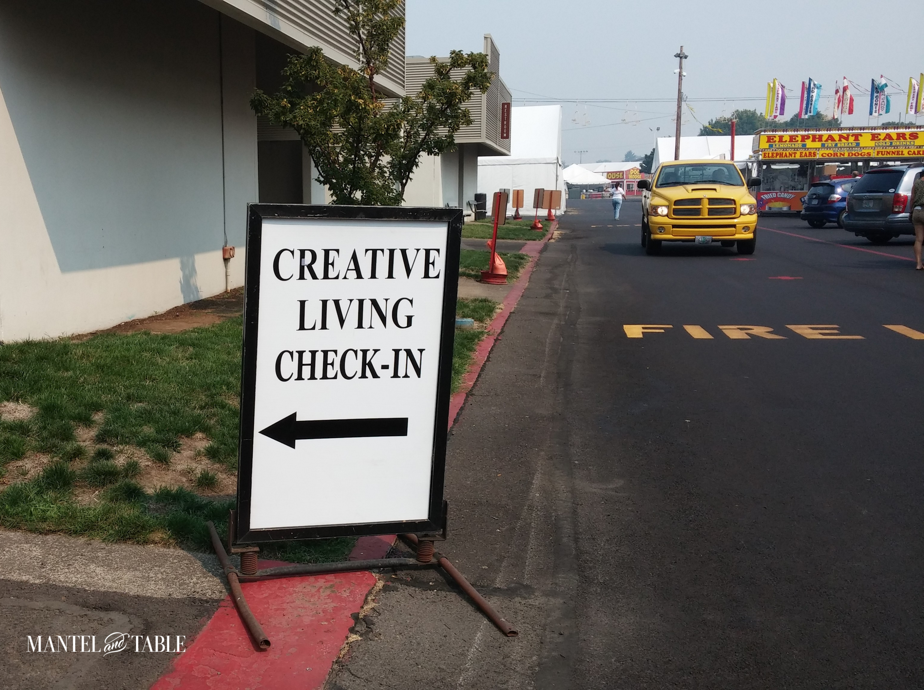 Creative Living Check In sign pointing the way to the tablescape setup area