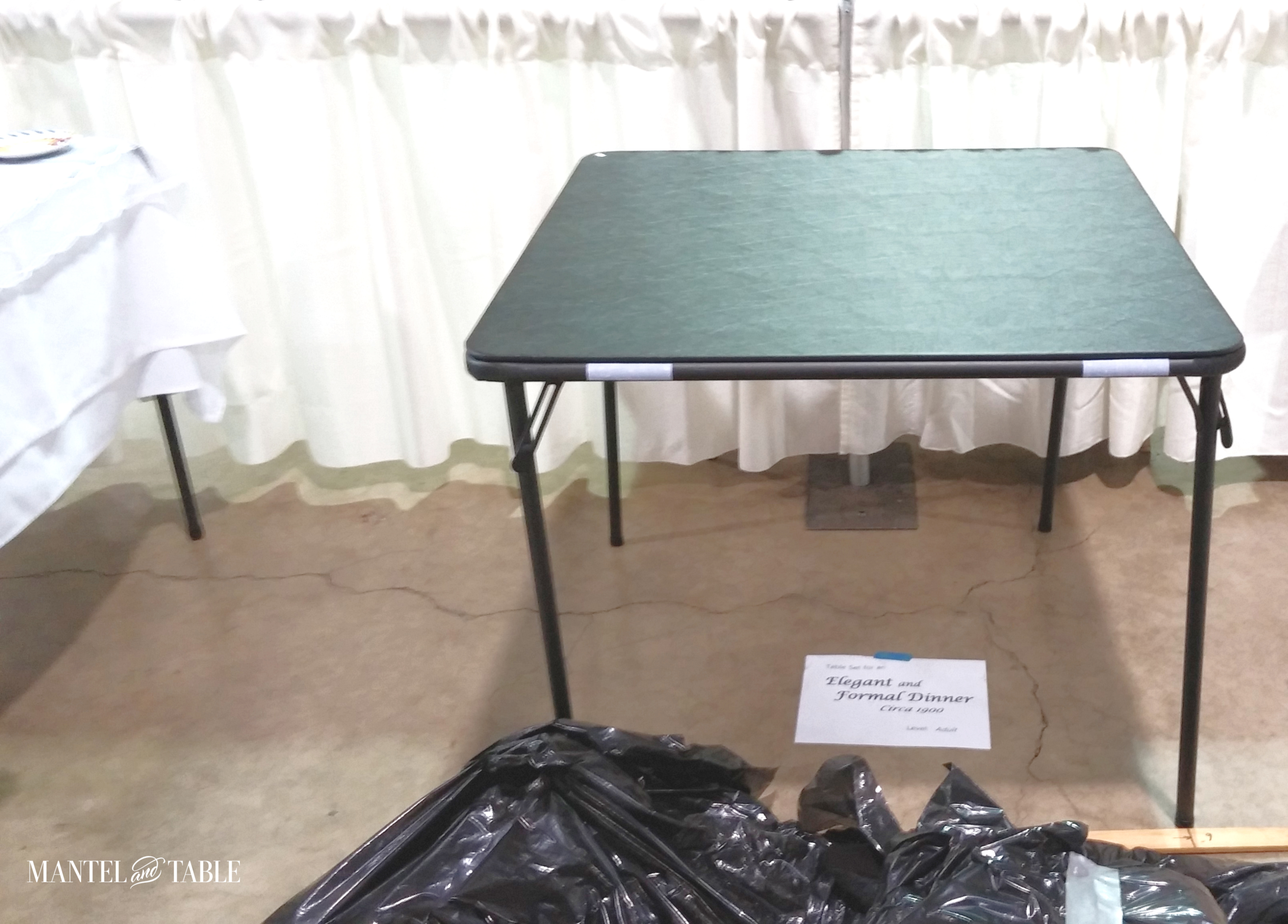 Card table on bare floor ready for tablescape setup