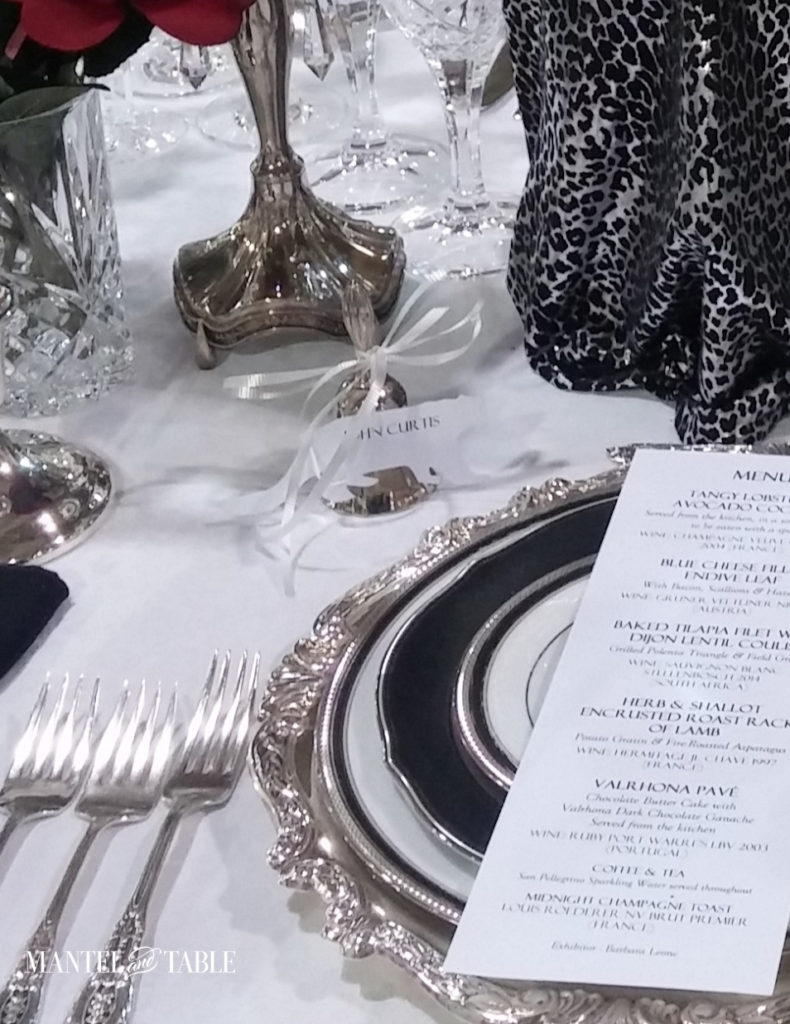 Closeup of snow leopard place card on silver bell