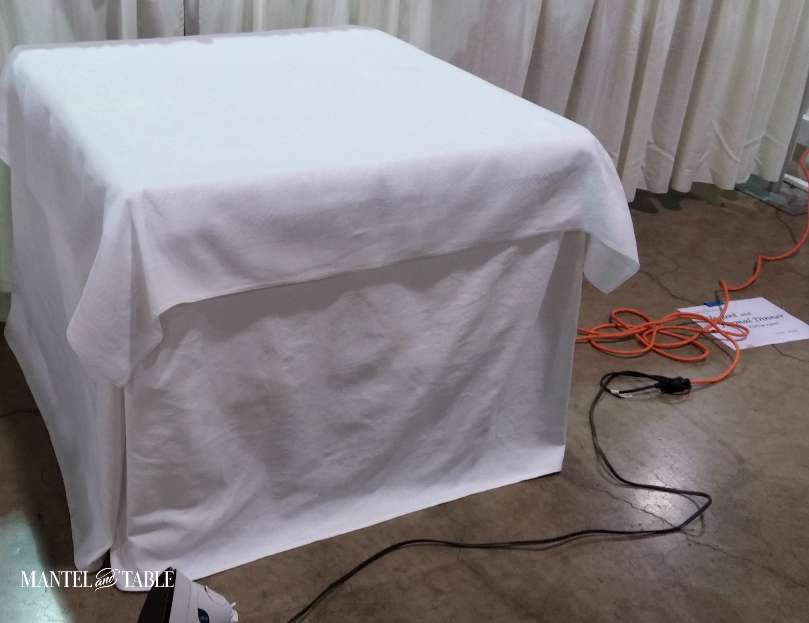 Dumb looking table skirt, but the linens are pressed for this tablescape setup