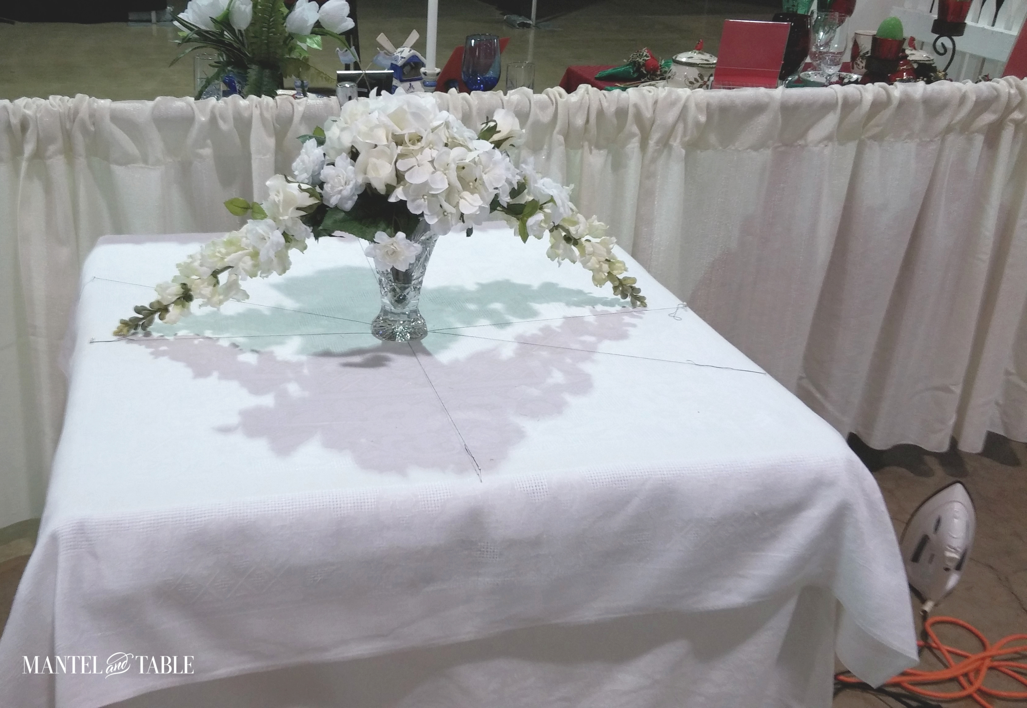 White flower arrangement in the center of table