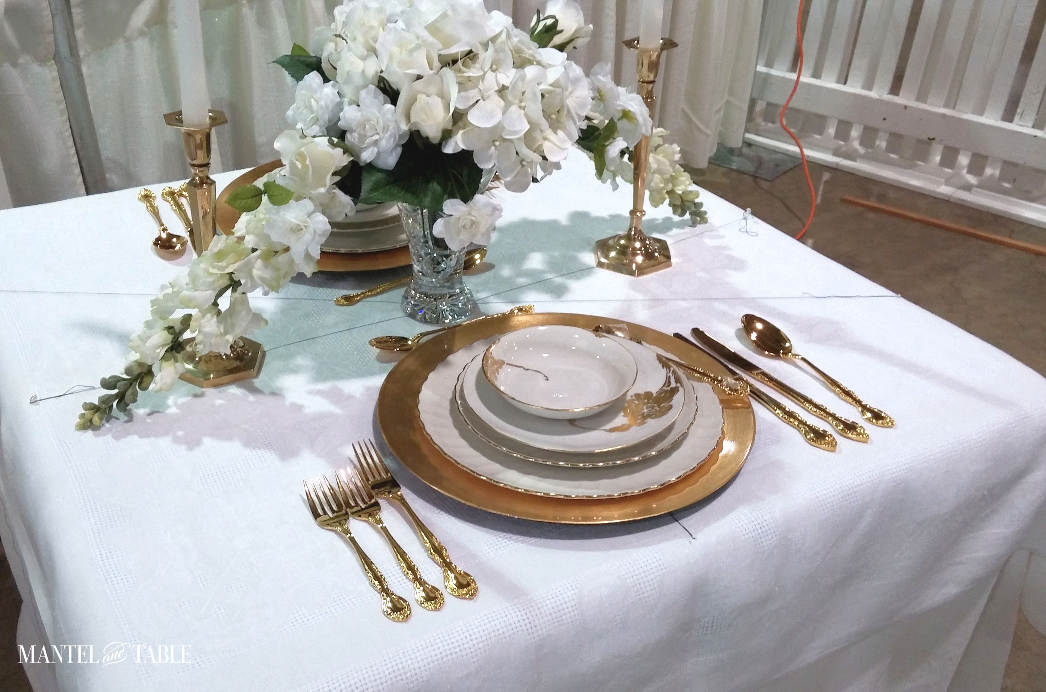 Gold flatware added to tablescape setup