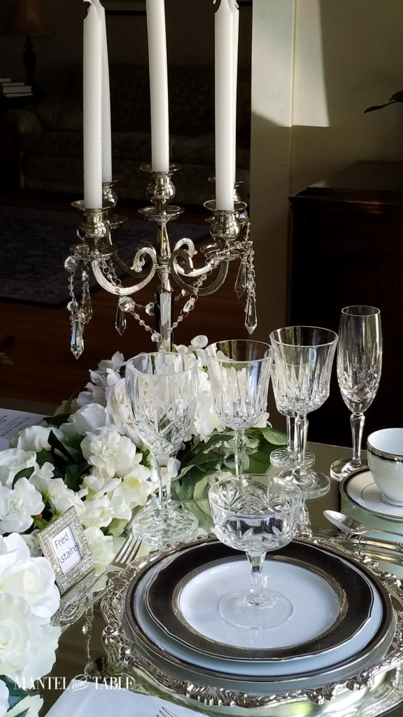 Crystal glasses and silver candelabra at place setting