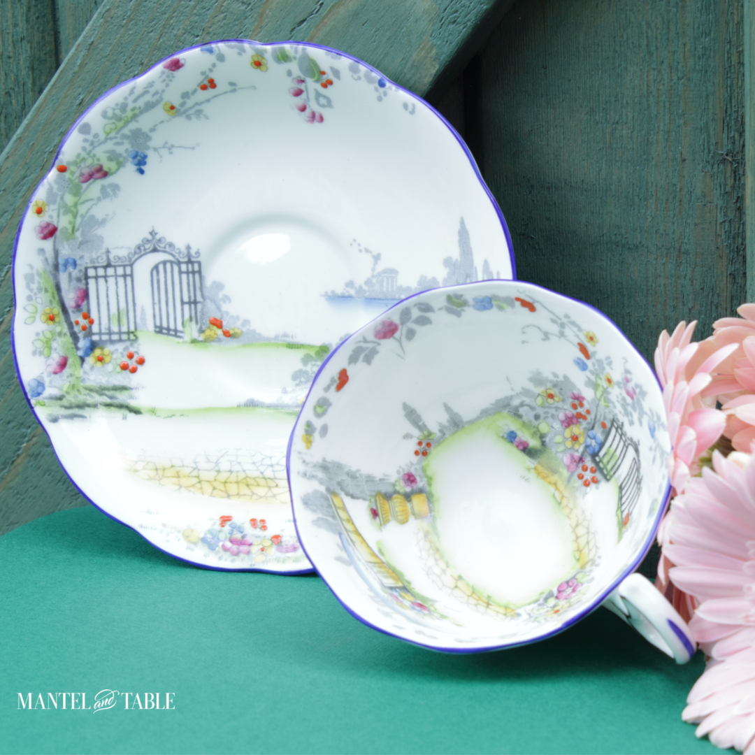 Closeup of Rosedale teacup and saucer with pink flowers & green gate