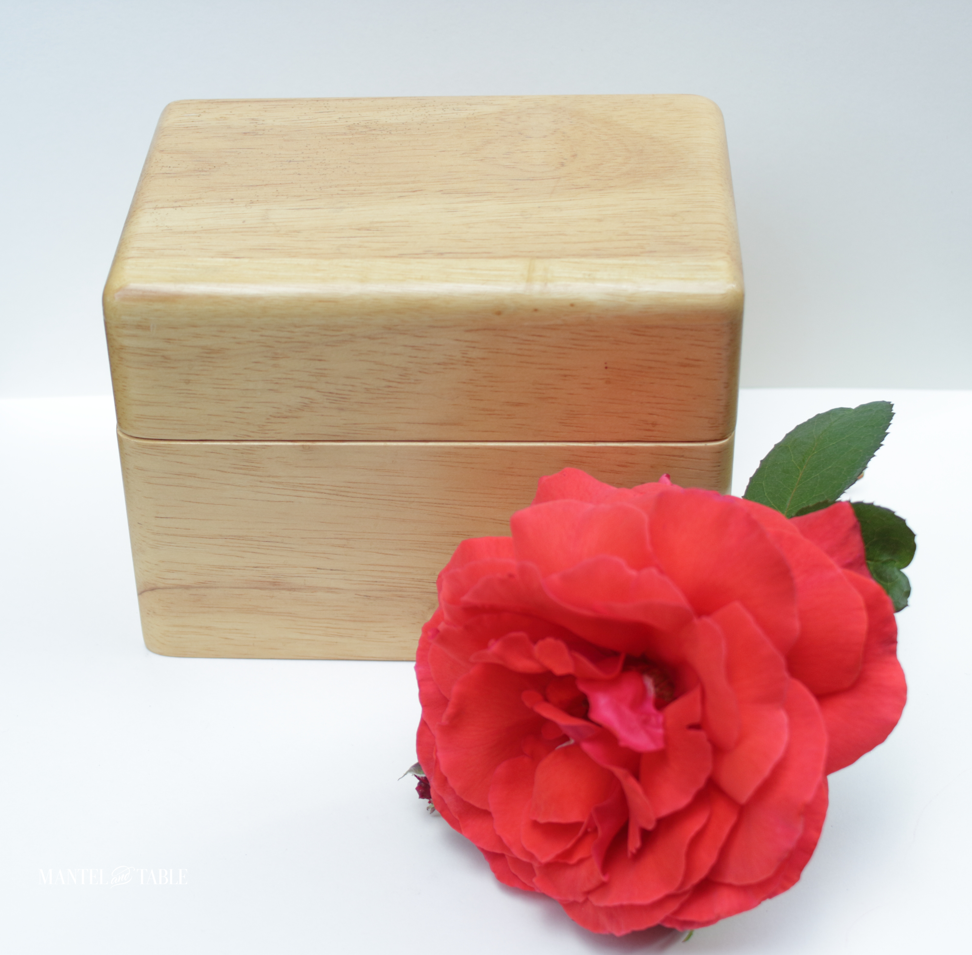 Closed wooden card file box with red rose