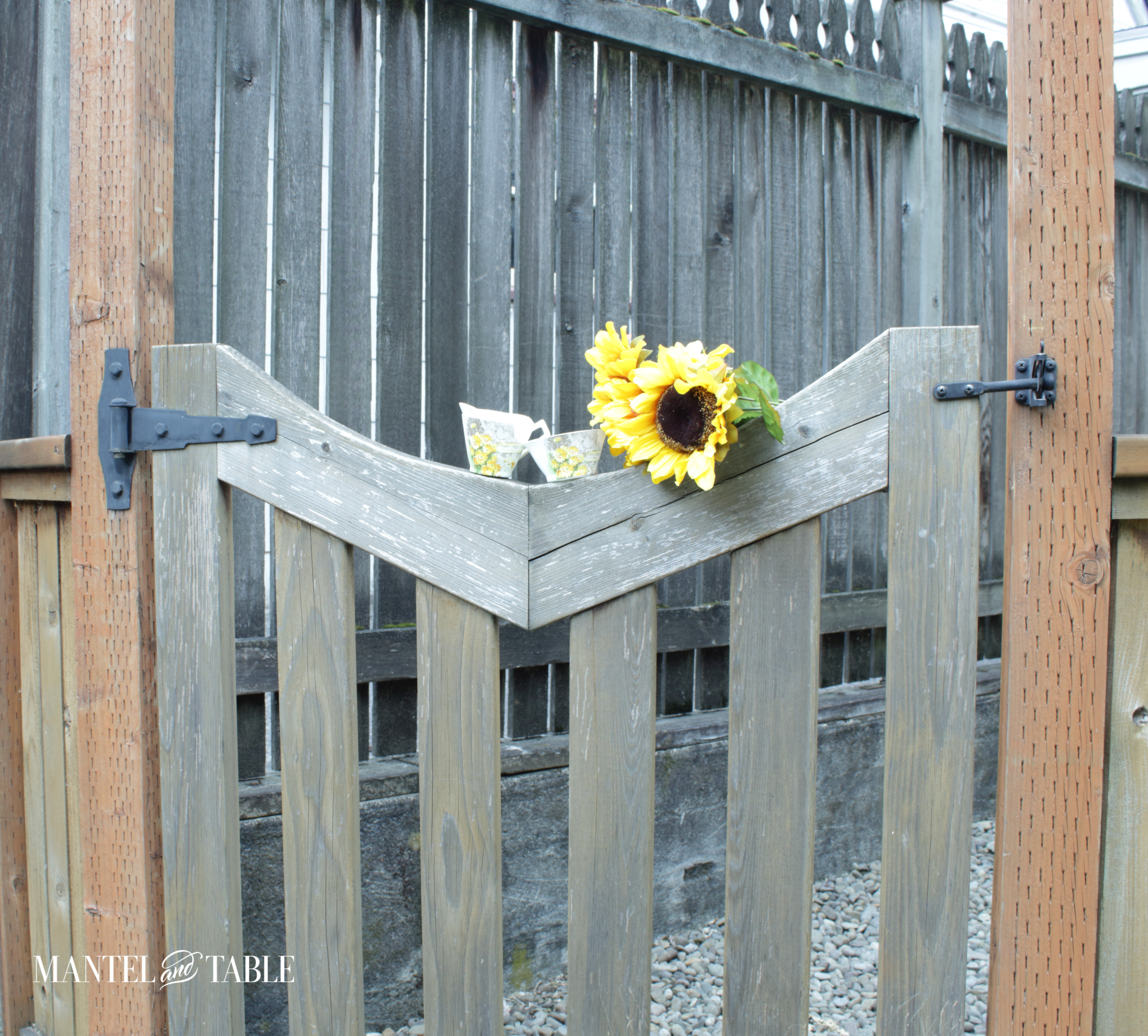 sugar & creamer with sunflowers on top of the gate