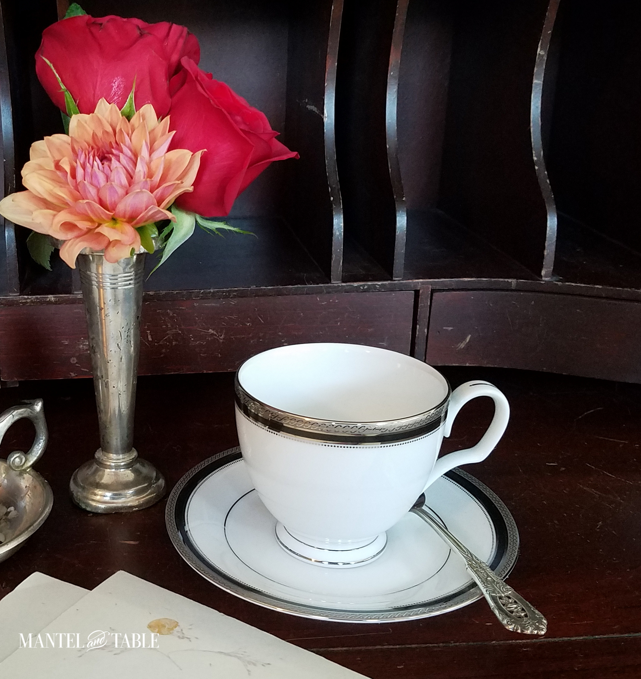 teacup & flowers on brown secretary desk