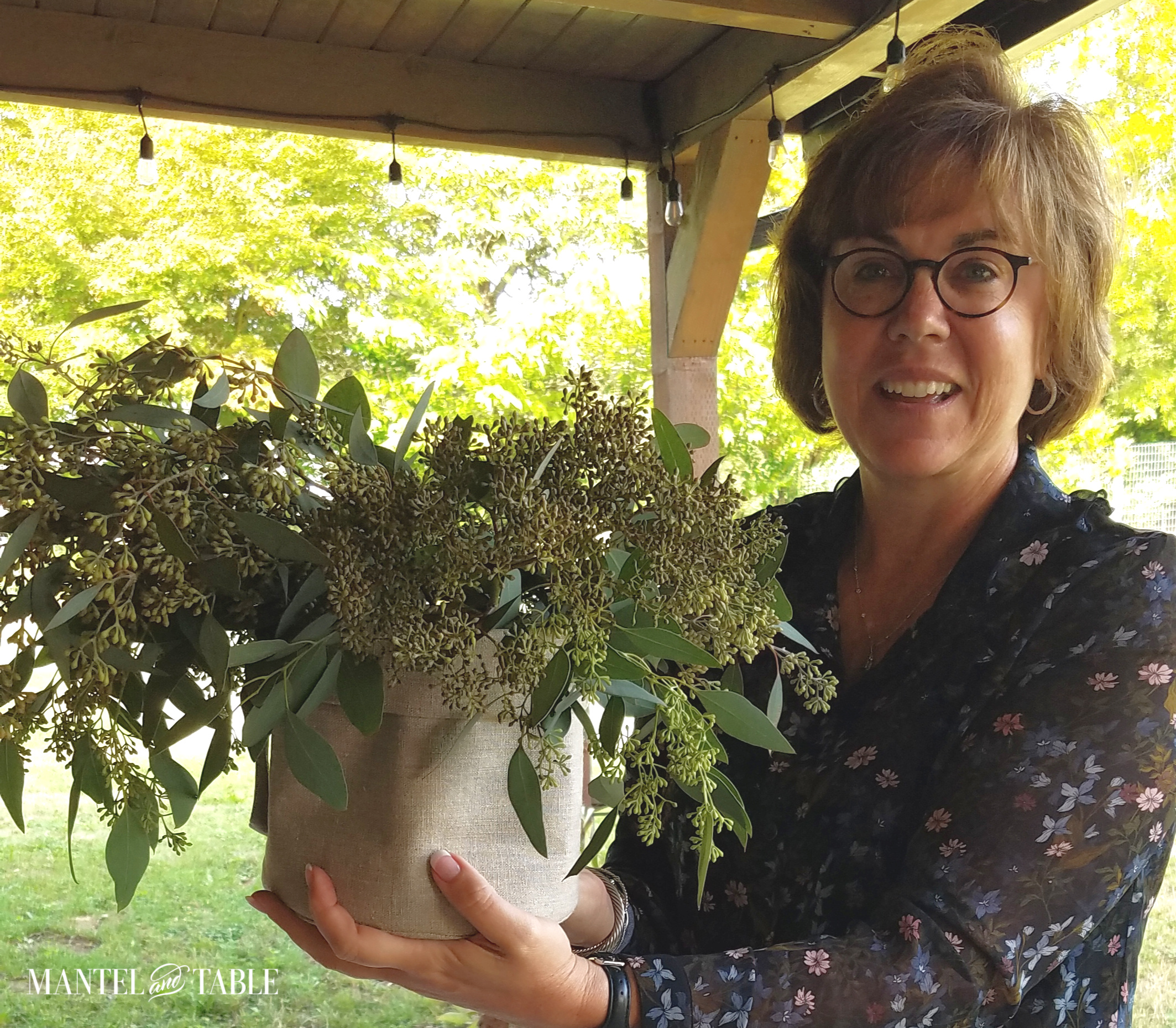 Jamie Jamison with greenery arrangement