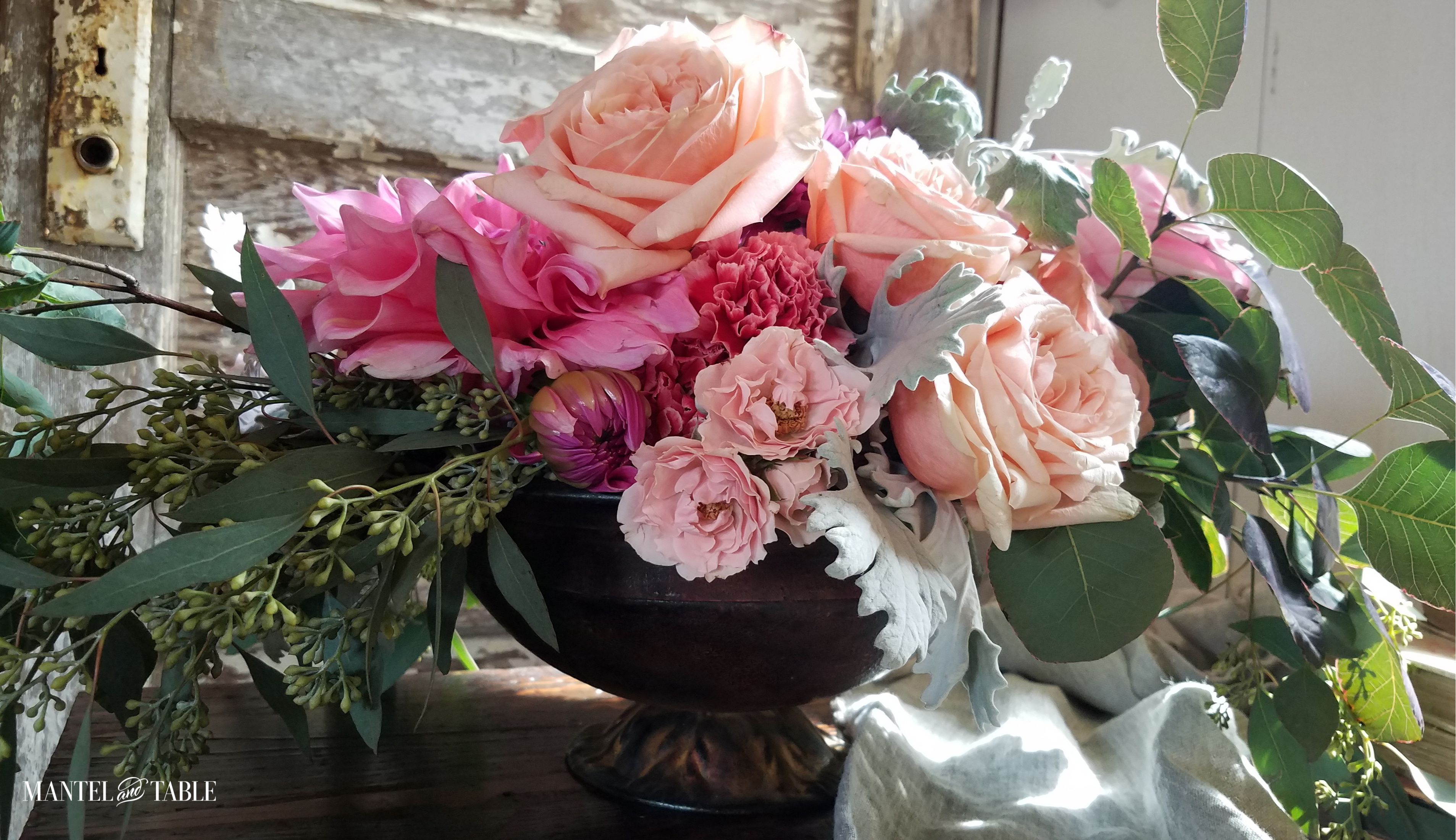 Mantel and Table supports Habitat for Humanity ~ Pink & Blush roses with seeded eucalyptus in a vintage footed bowl