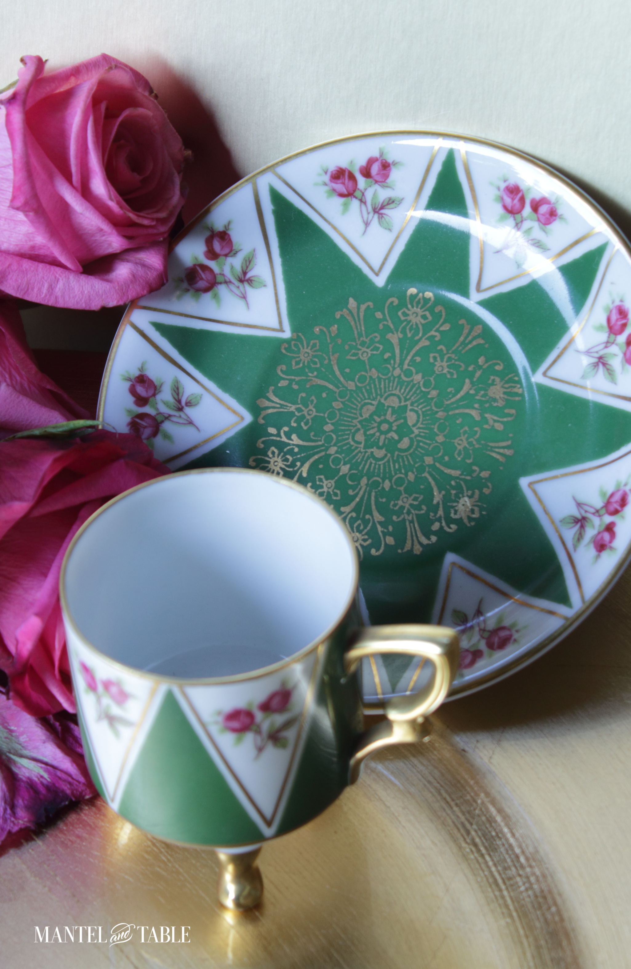 Demitasse teacup and saucer with gold design in the middle