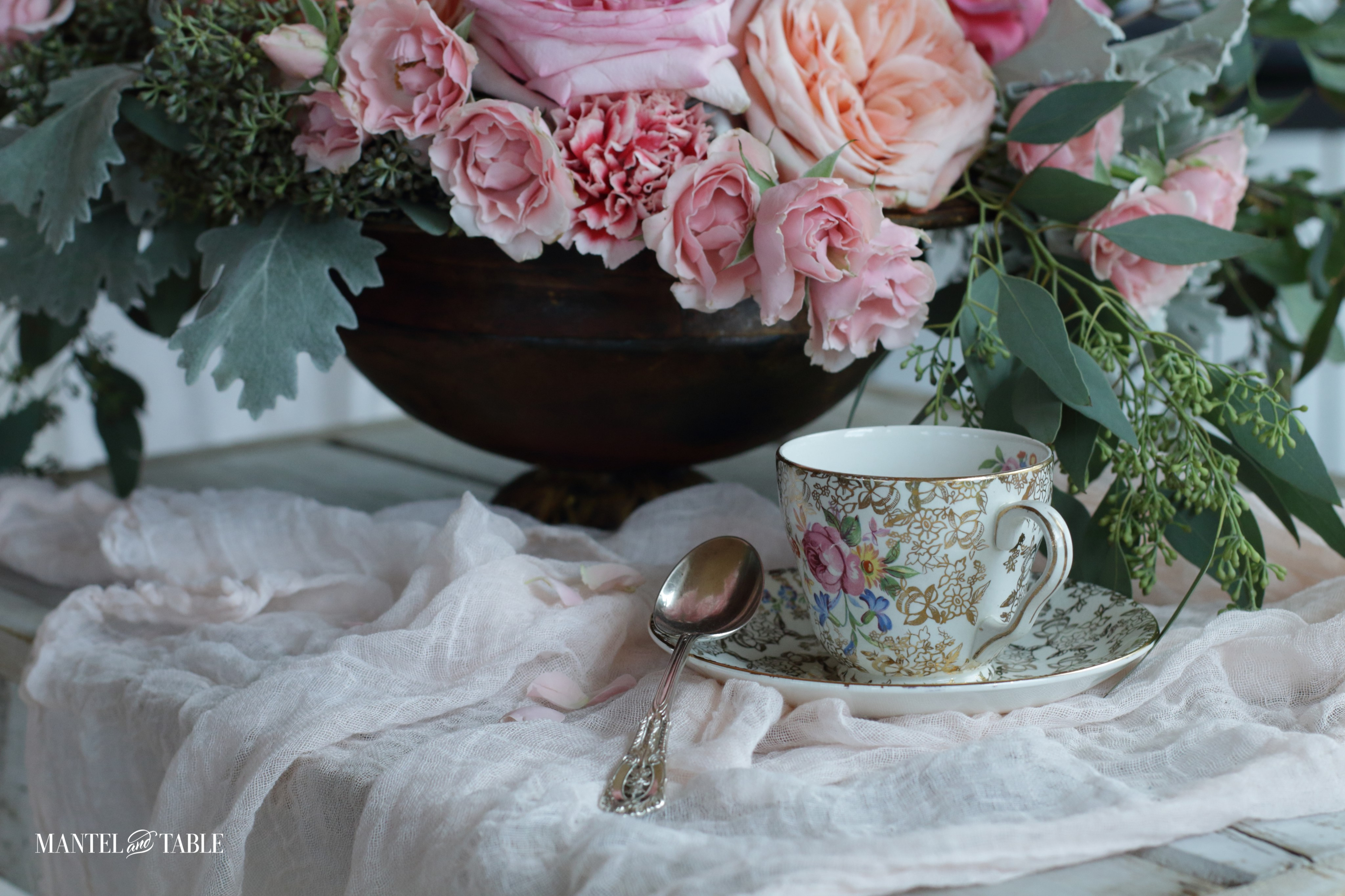 Vintage teacup and saucer on pink fabric