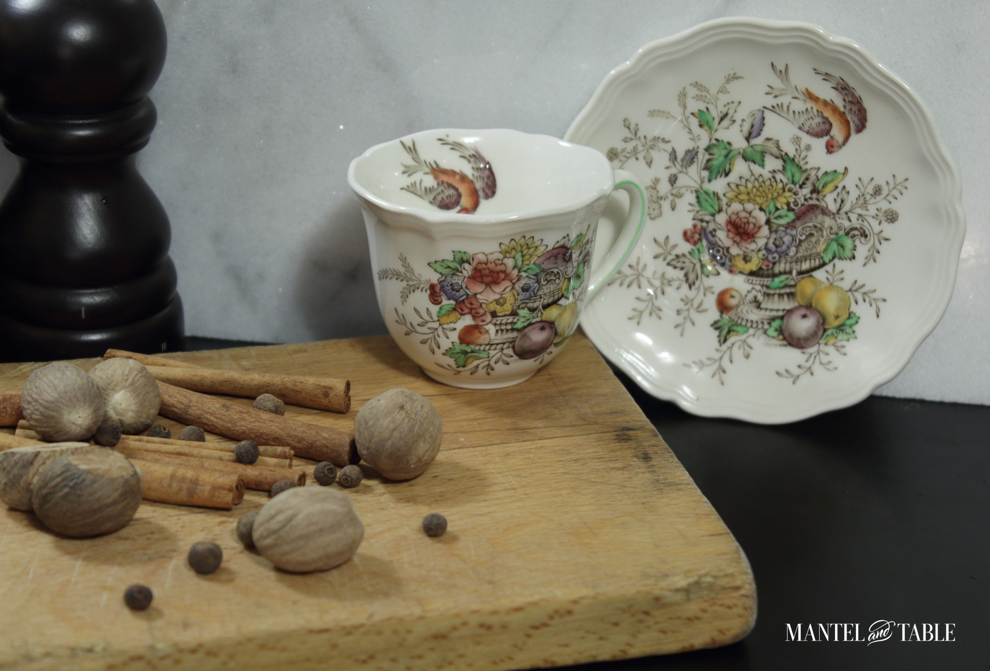 Teacup & Saucer on counter with cinnamon, allspice, cloves