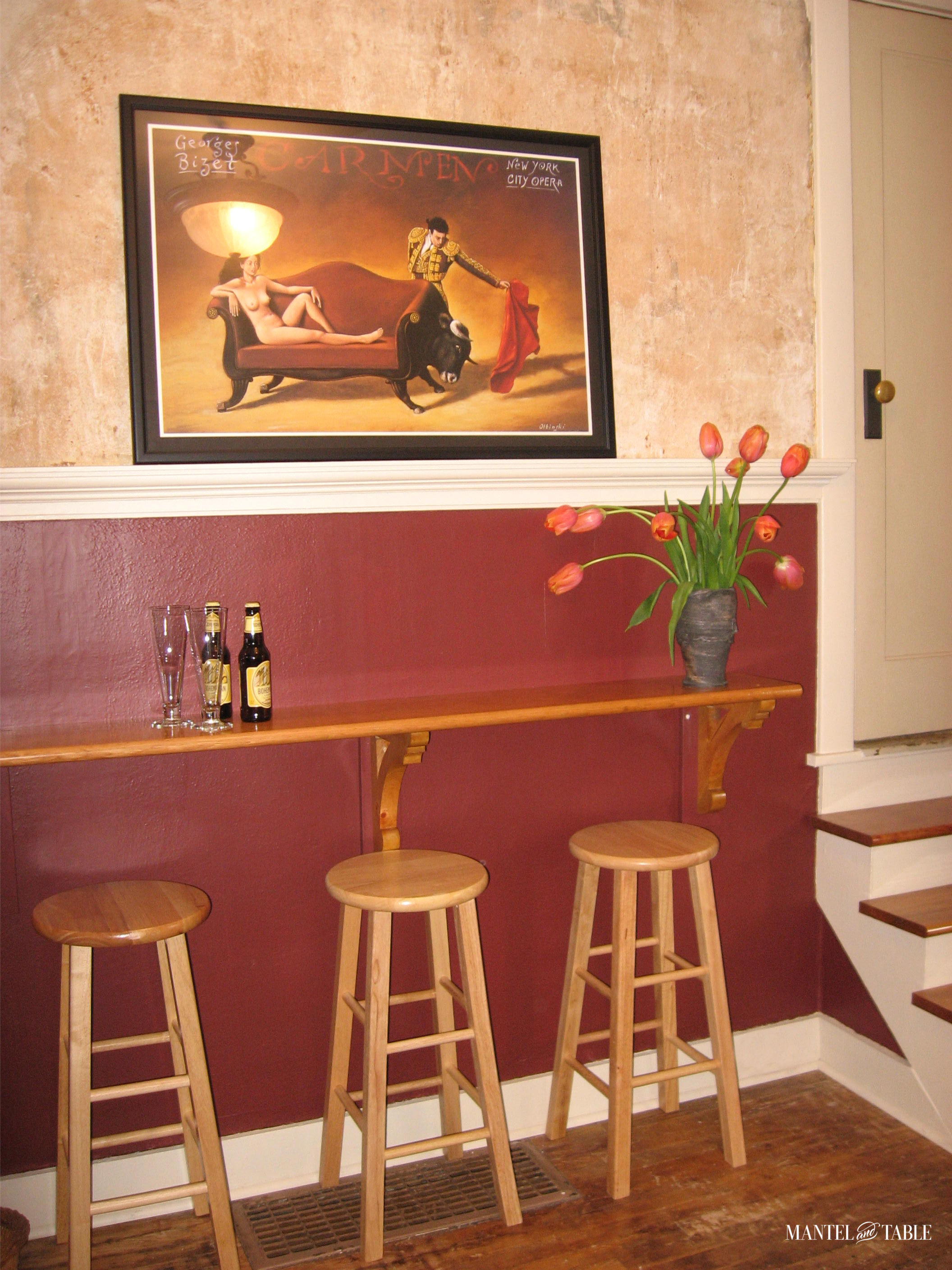 View of "pub" room with bar and 3 wooden bar stools