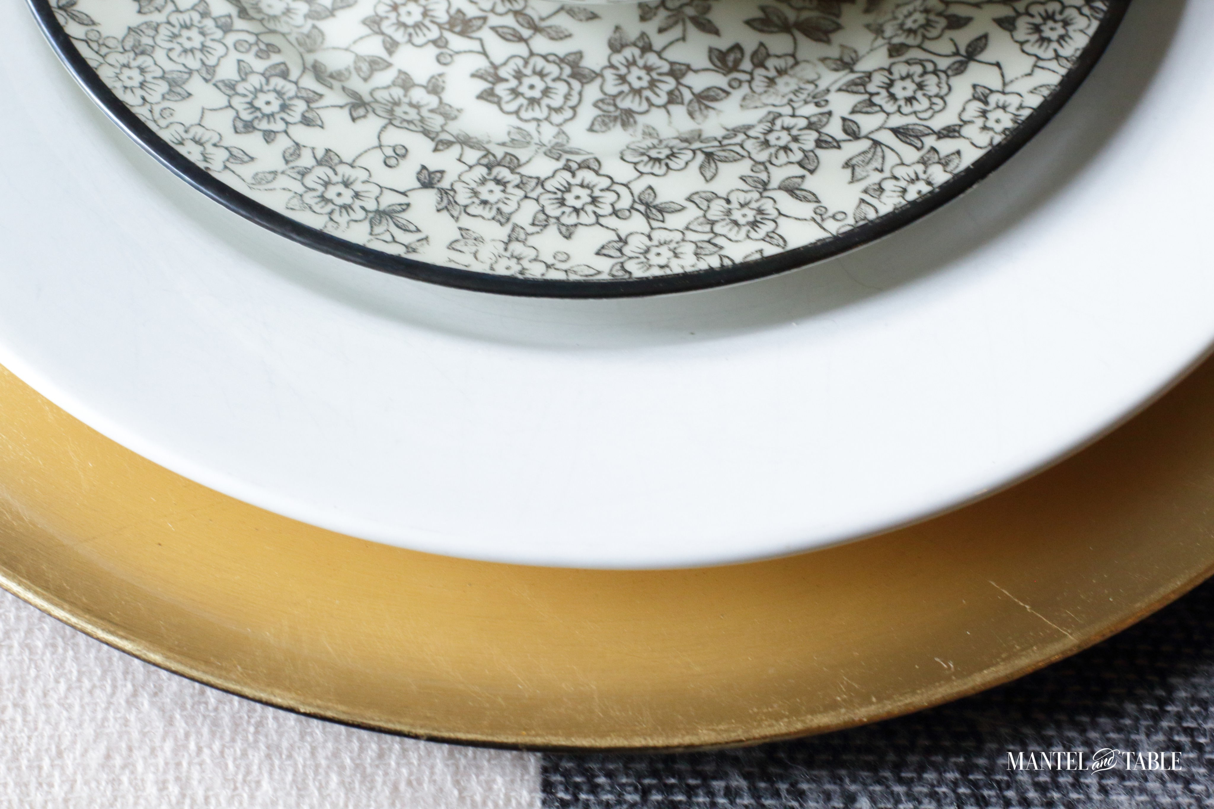 Moody Fall Table view of plate stack: gold, white, black transferware floral