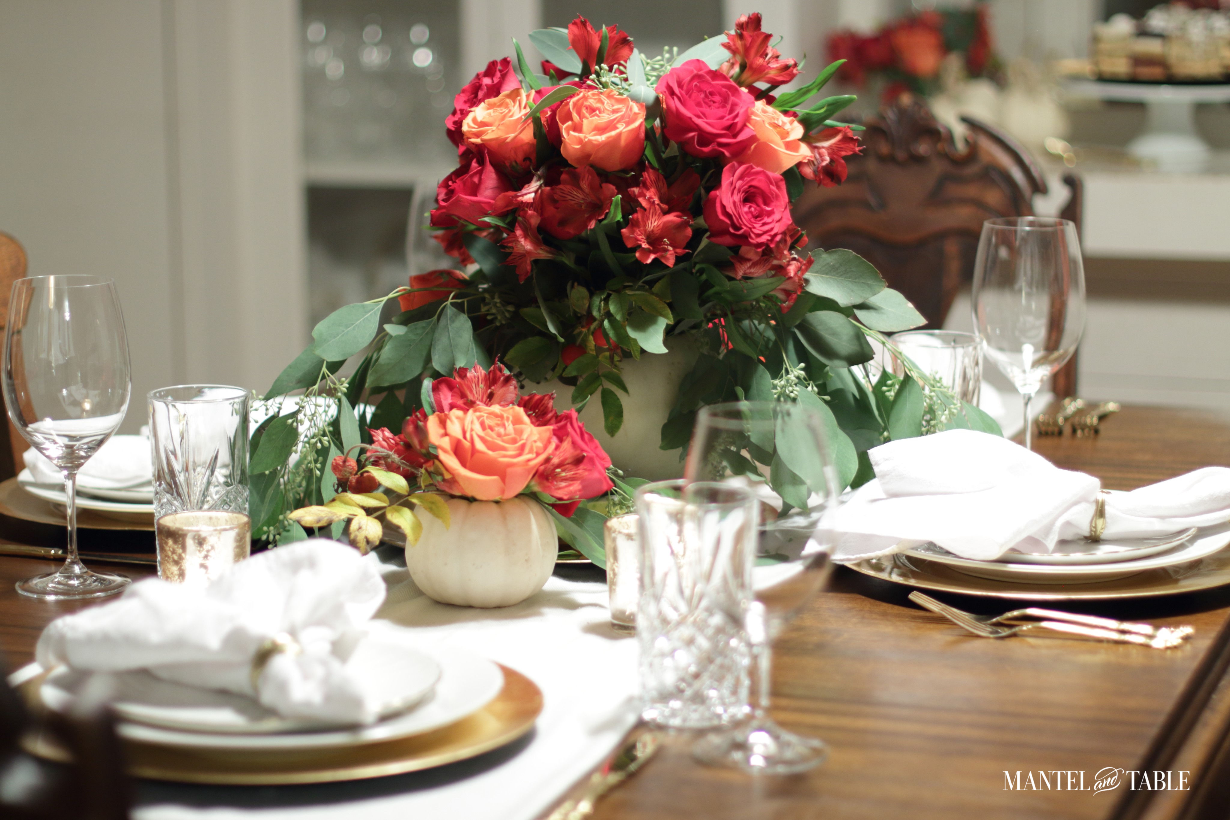White pumpkin flower arrangement table set with white cotton scarf runner