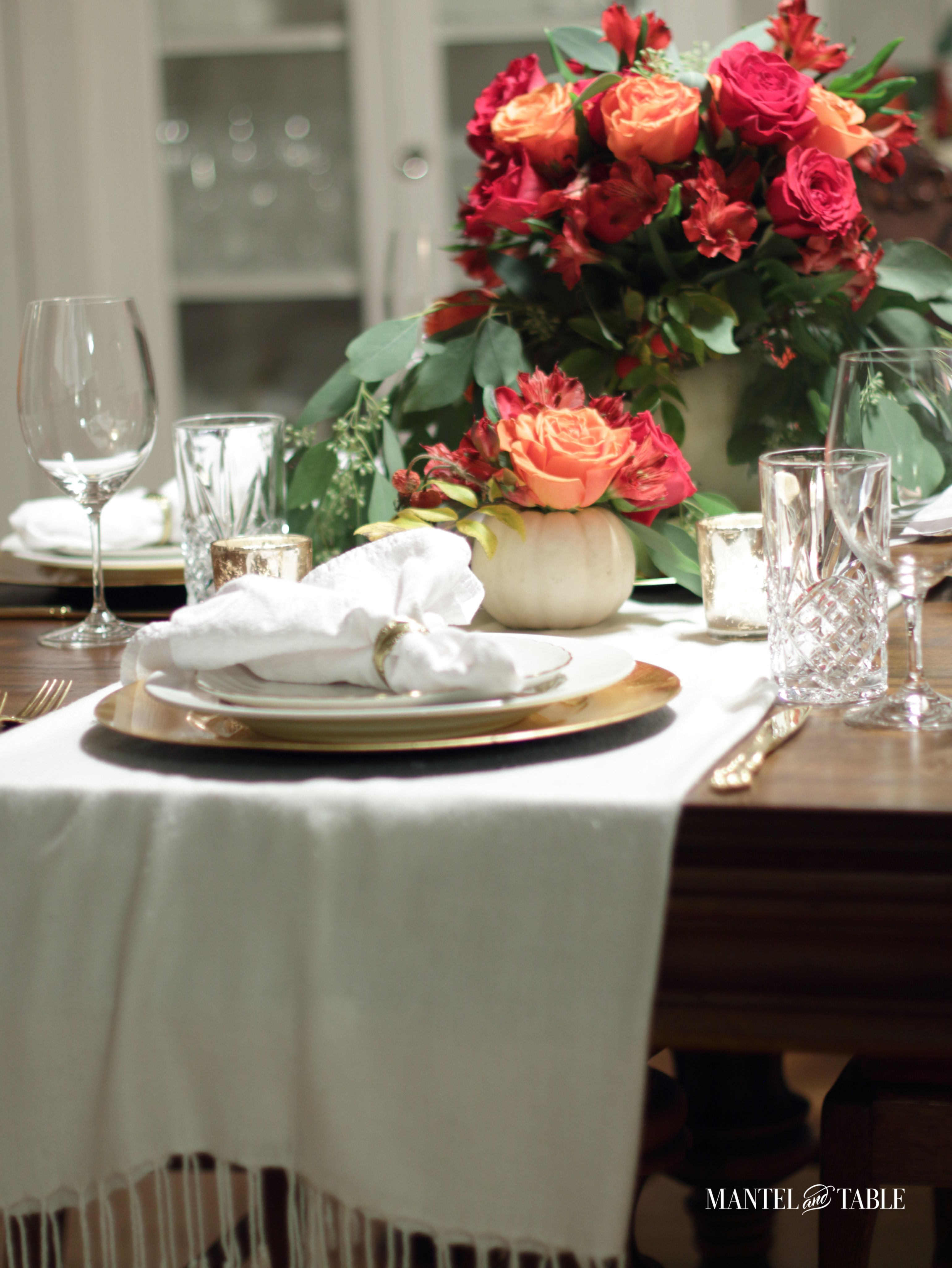 White pumpkin flower arrangement centerpieces on the table