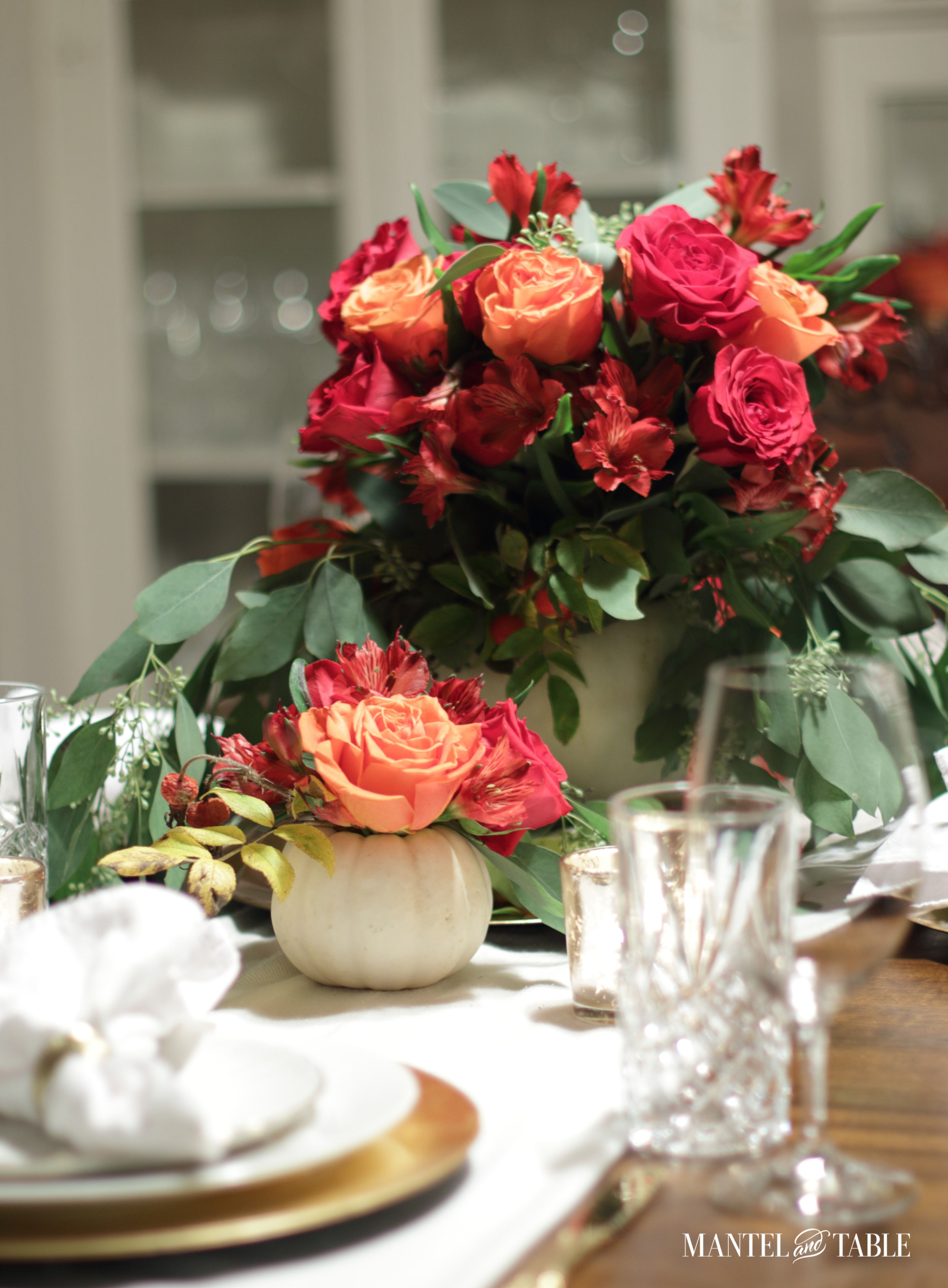 White pumpkin flower arrangement centerpieces on the table