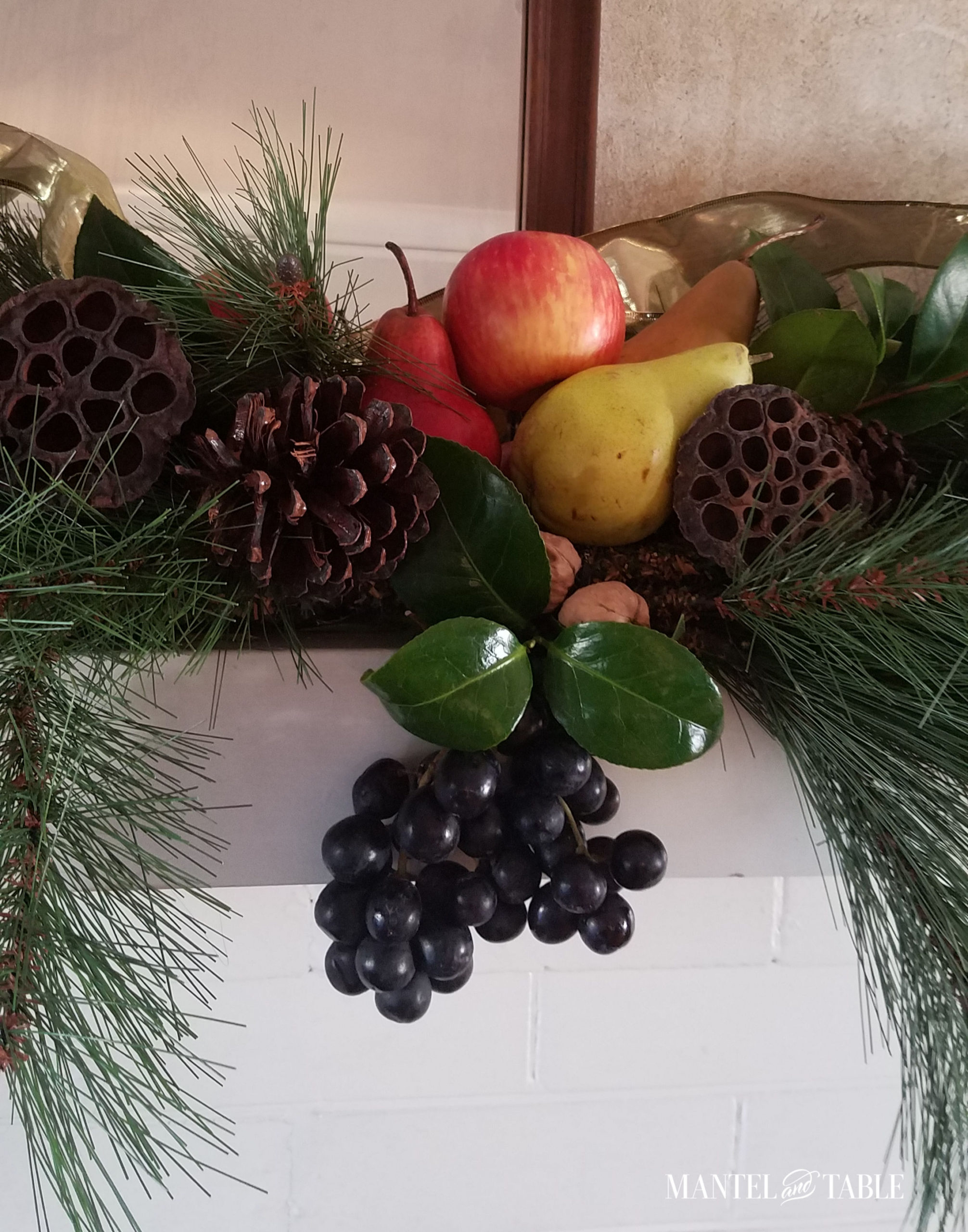 Harvest mantel with fruit centerpiece & gold ribbon