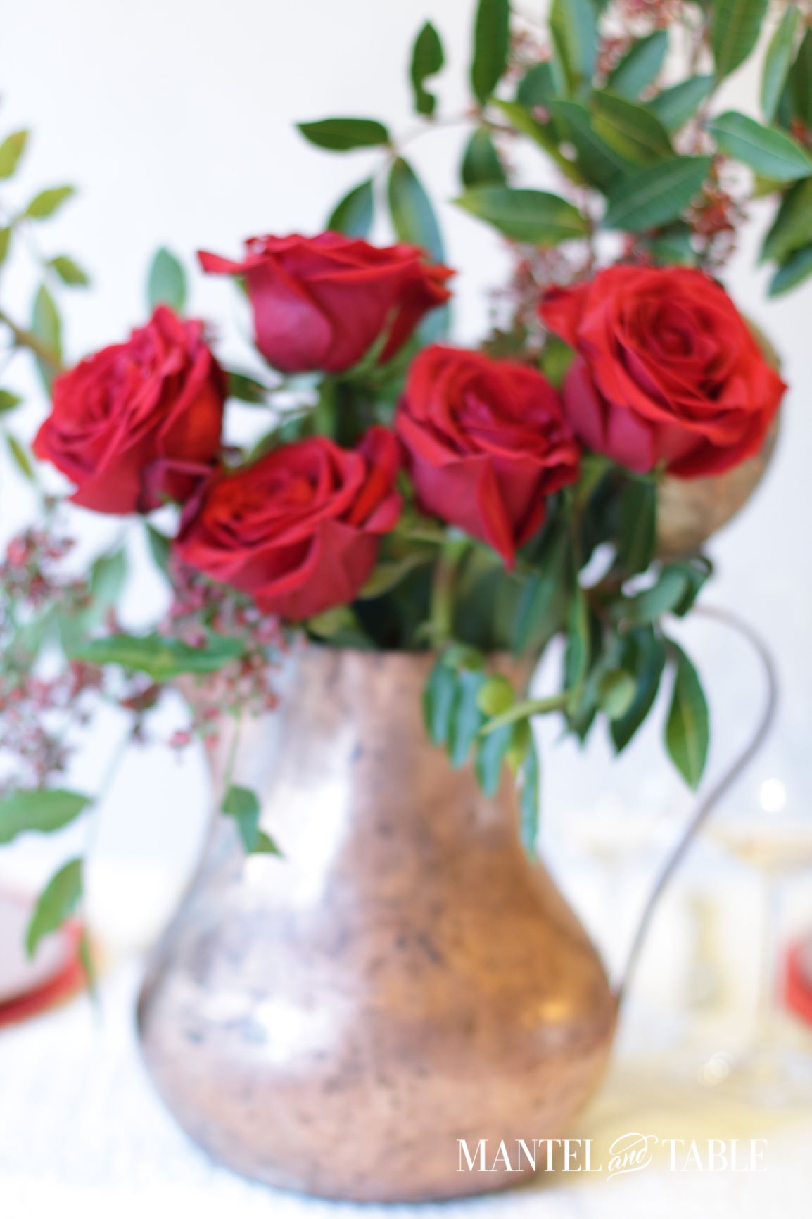 Christmas Tablescape ~ Centerpiece with red roses and pepperberries in a copper pitcher