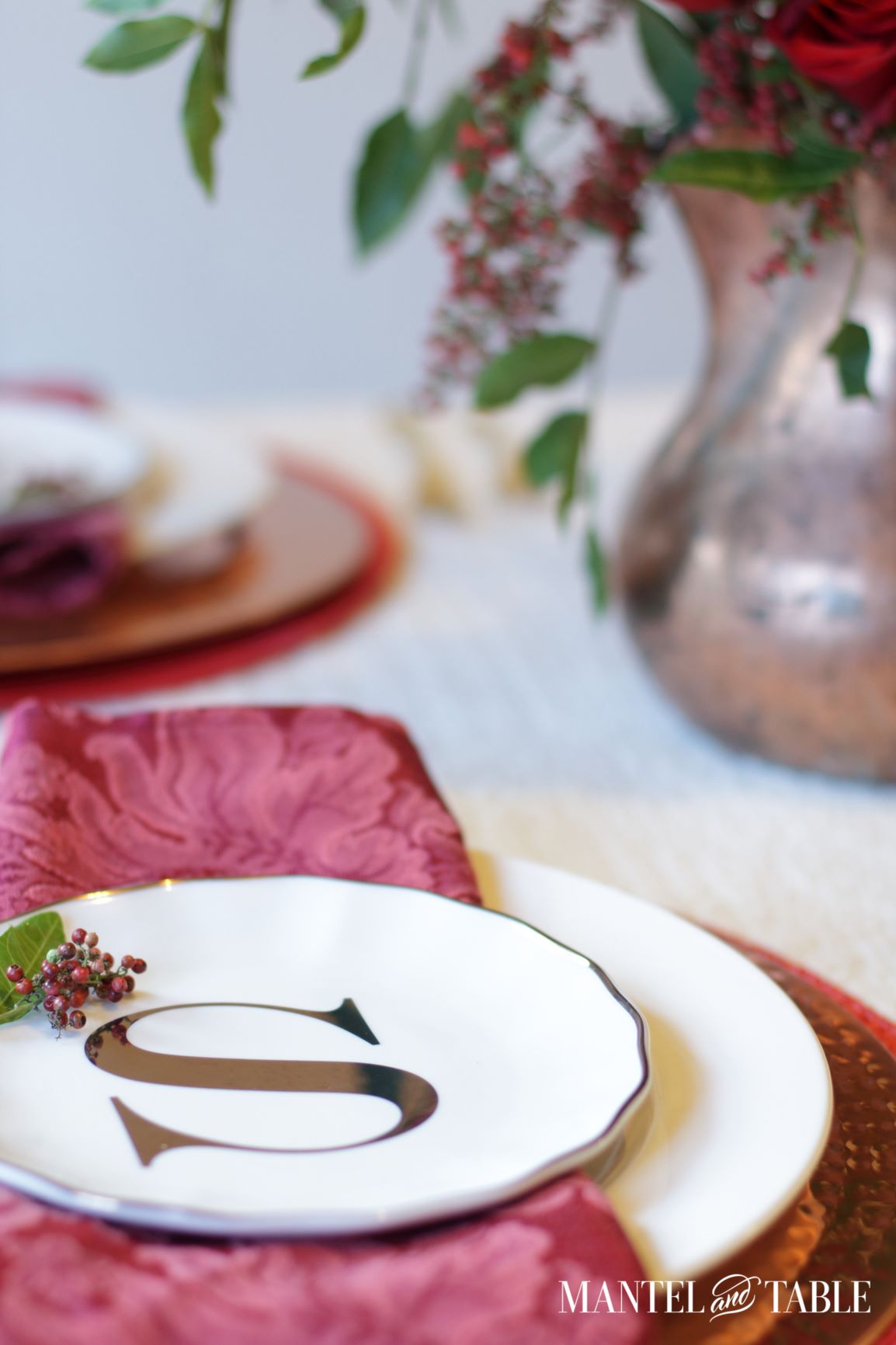 Christmas Tablescape ~ monogrammed plate in stack with roses and pepperberries in copper pitcher