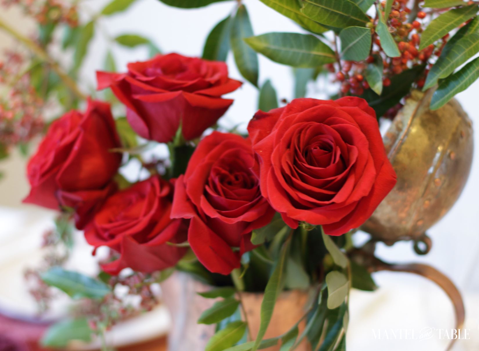 Christmas Tablescape ~ red roses, pink peppercorn berries in copper pitcher