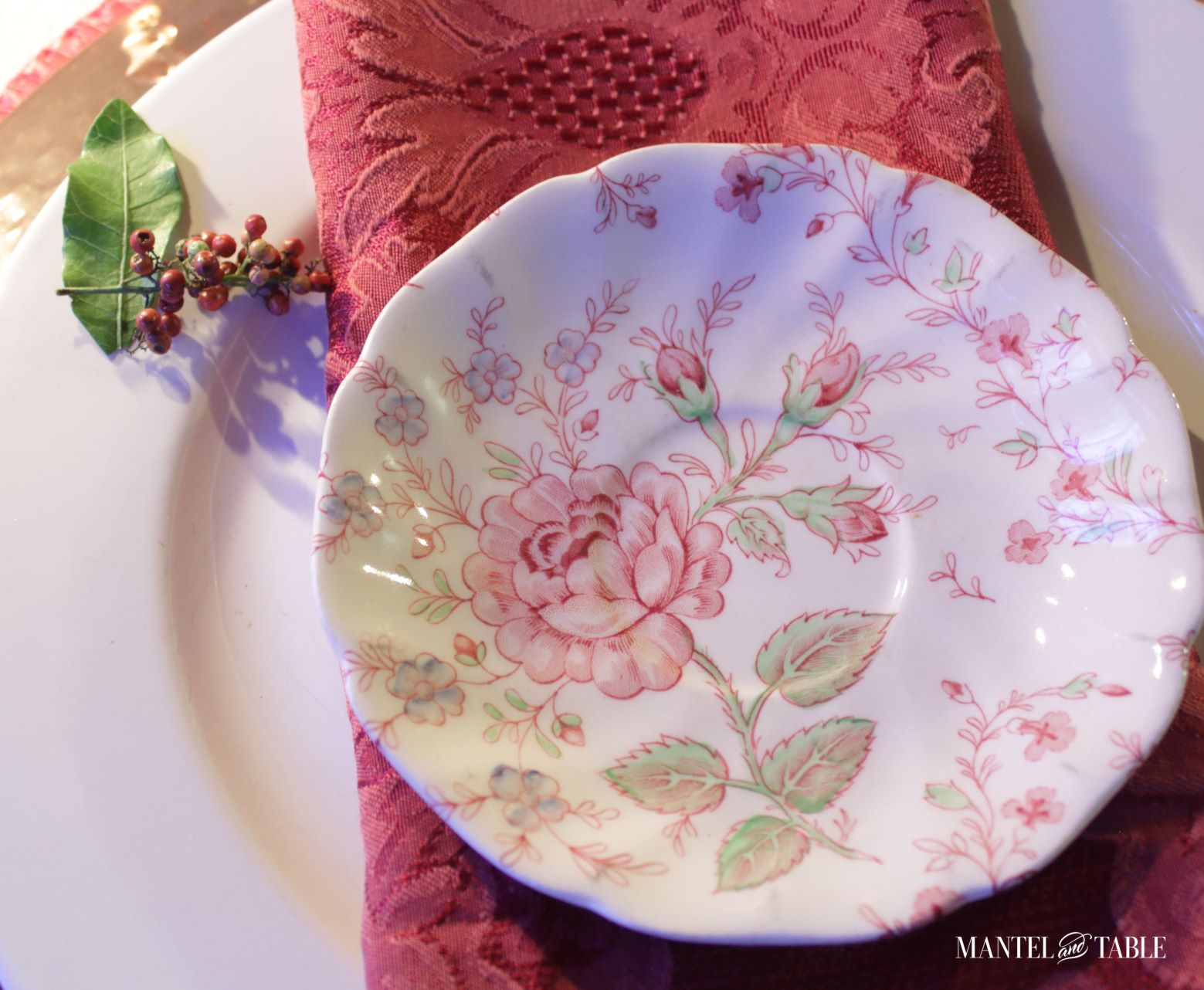 Saucer alone on red napkin and white dinner plate