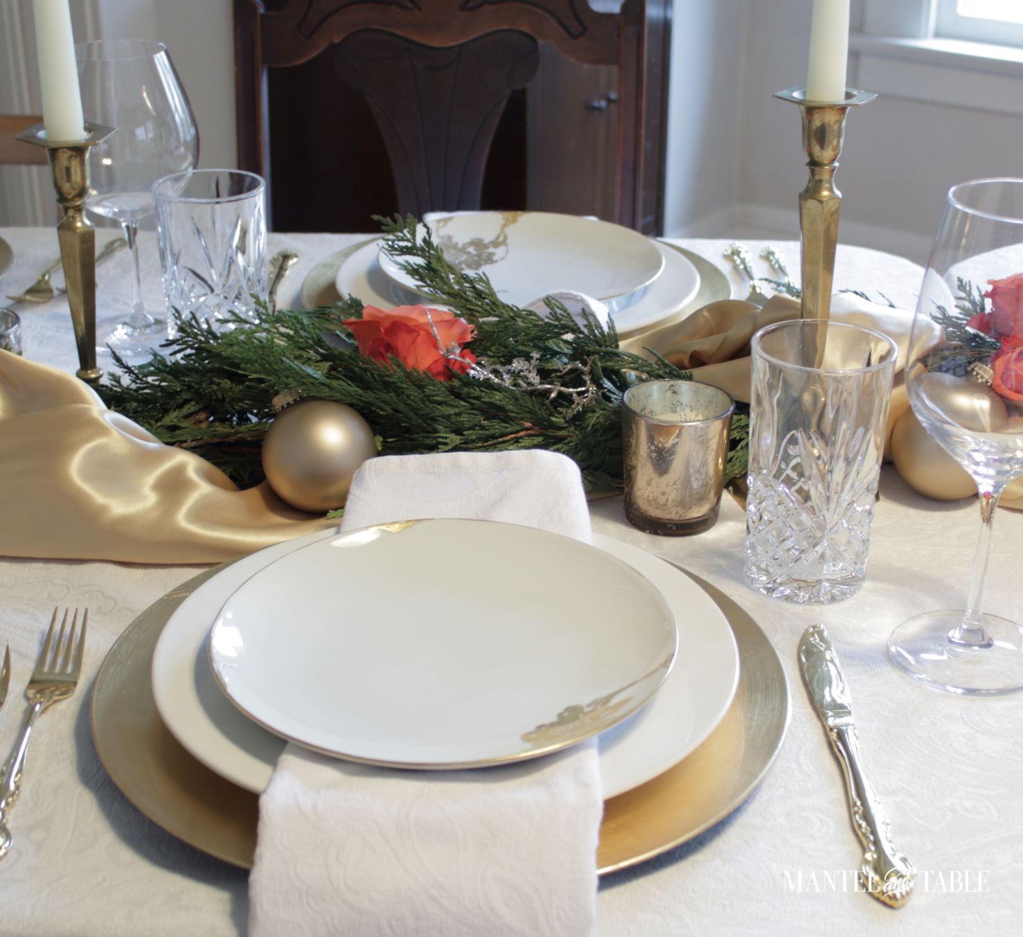 Gold satin tablescape. Two white and gold place settings across the table from each other