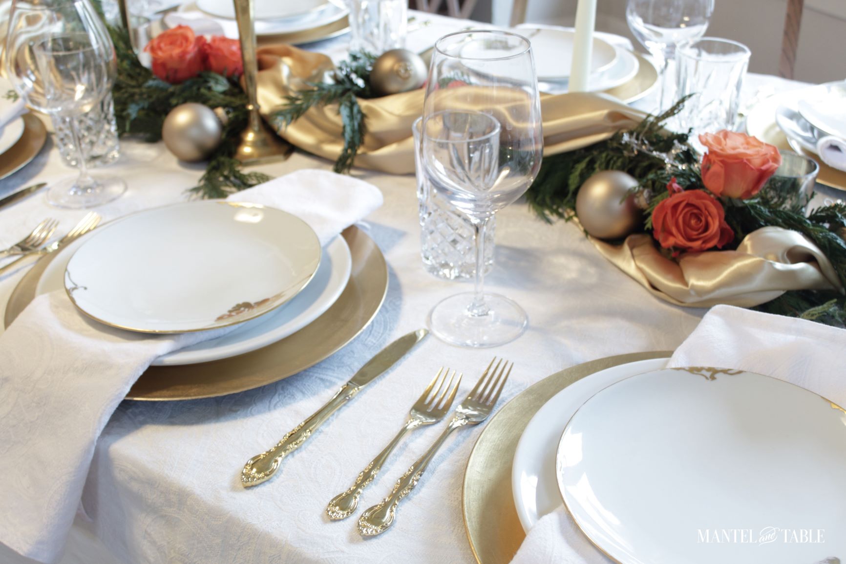 Two place settings and gold satin garland centerpiece