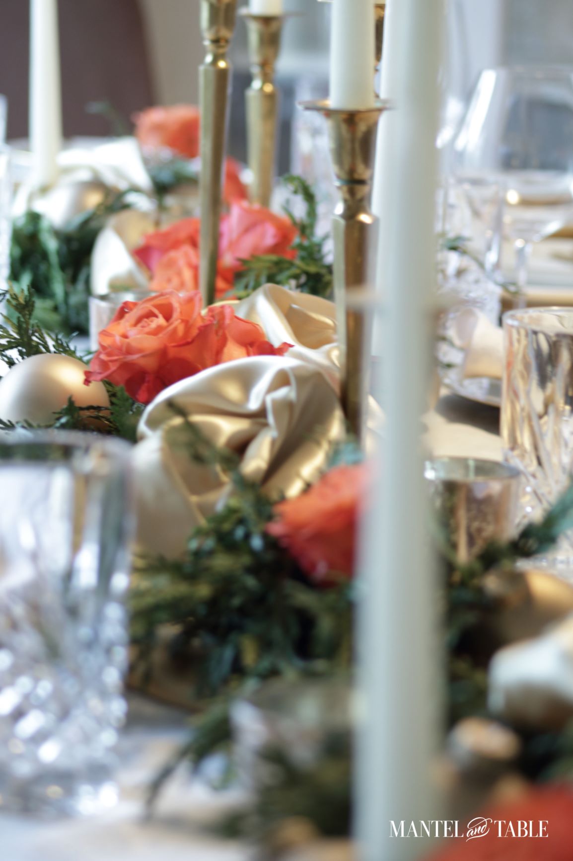Gold satin and peach roses in evergreen garland centerpiece