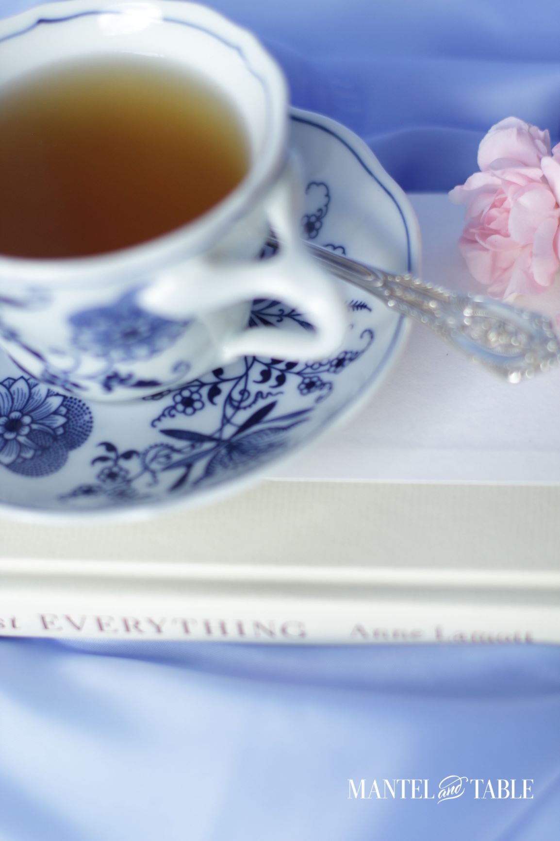 Closeup of tea in teacup, pink flowers