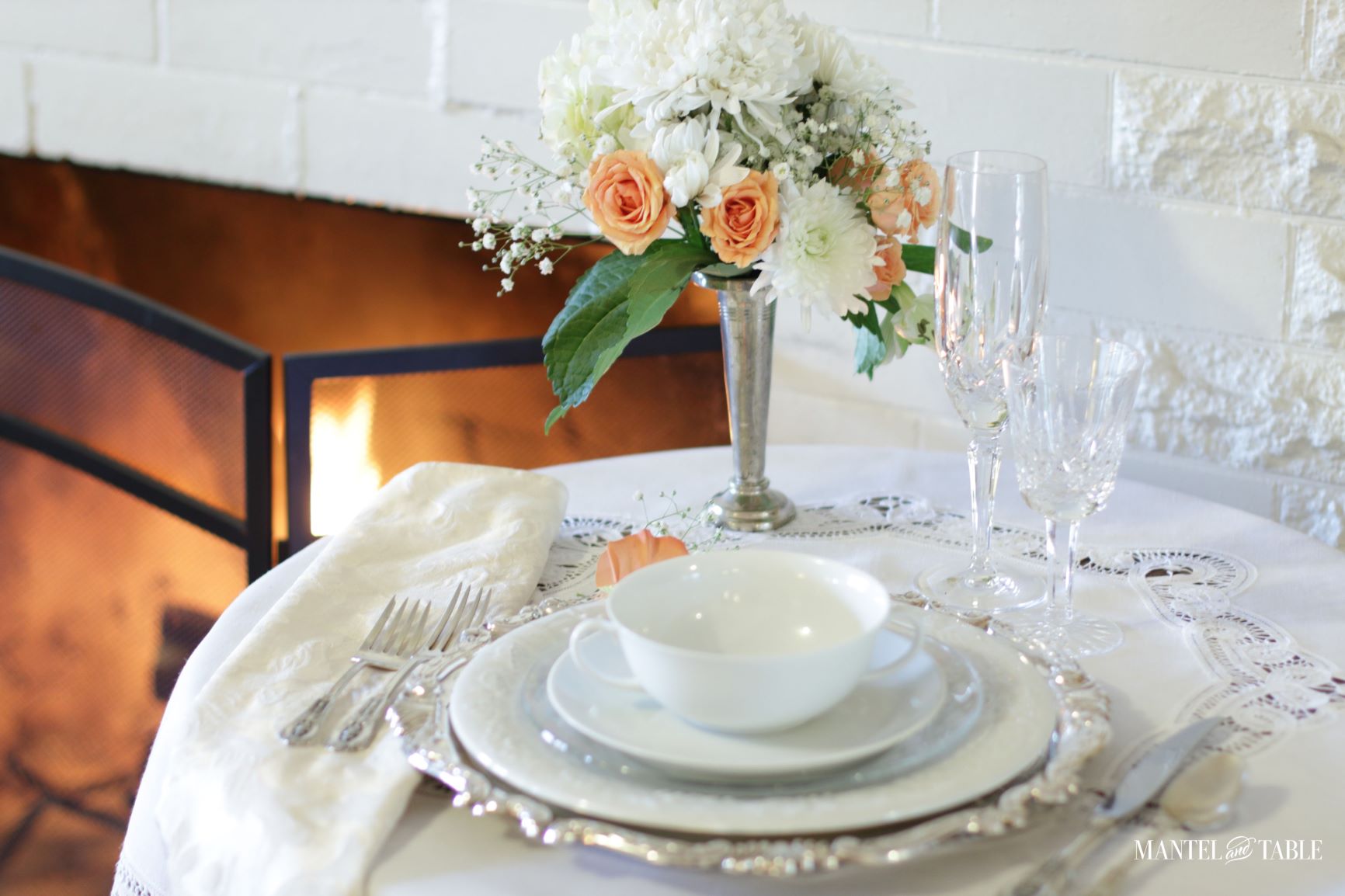 Table Setting for One ~ white, silver, and peach table setting by the fire