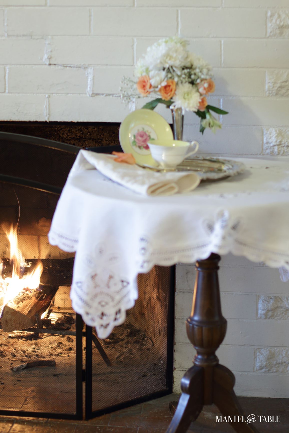 Lunch table for one by the fire, with teacup & saucer
