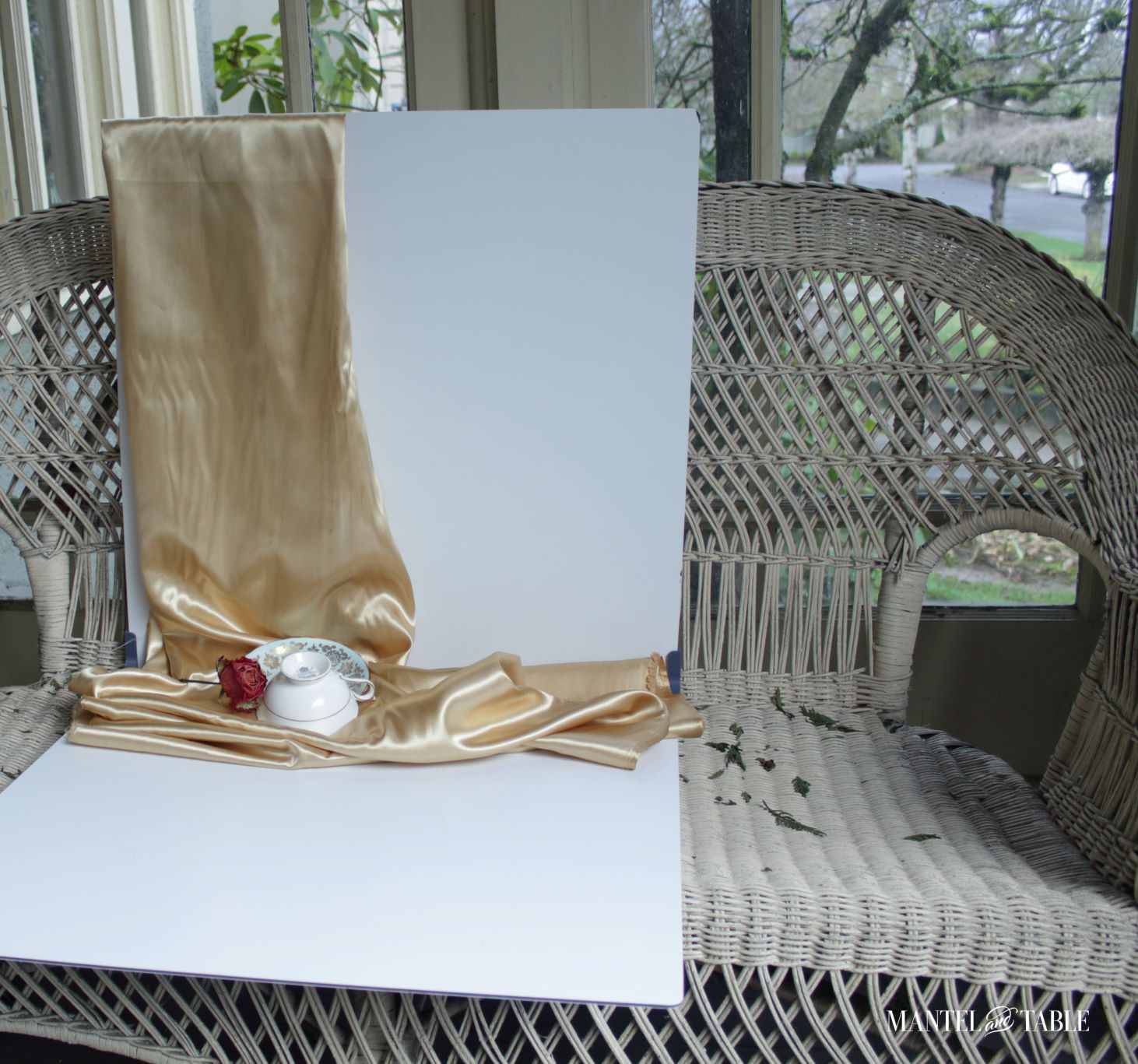 Teacup on white background resting on wicker bench