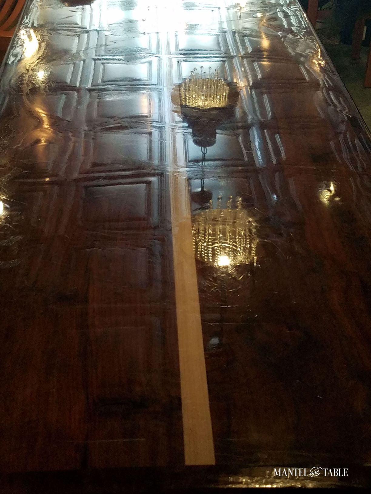 Brute Wine Bar Astoria OR ~ Glossy wood bar top reflecting chandeliers and patterned tin ceiling tiles
