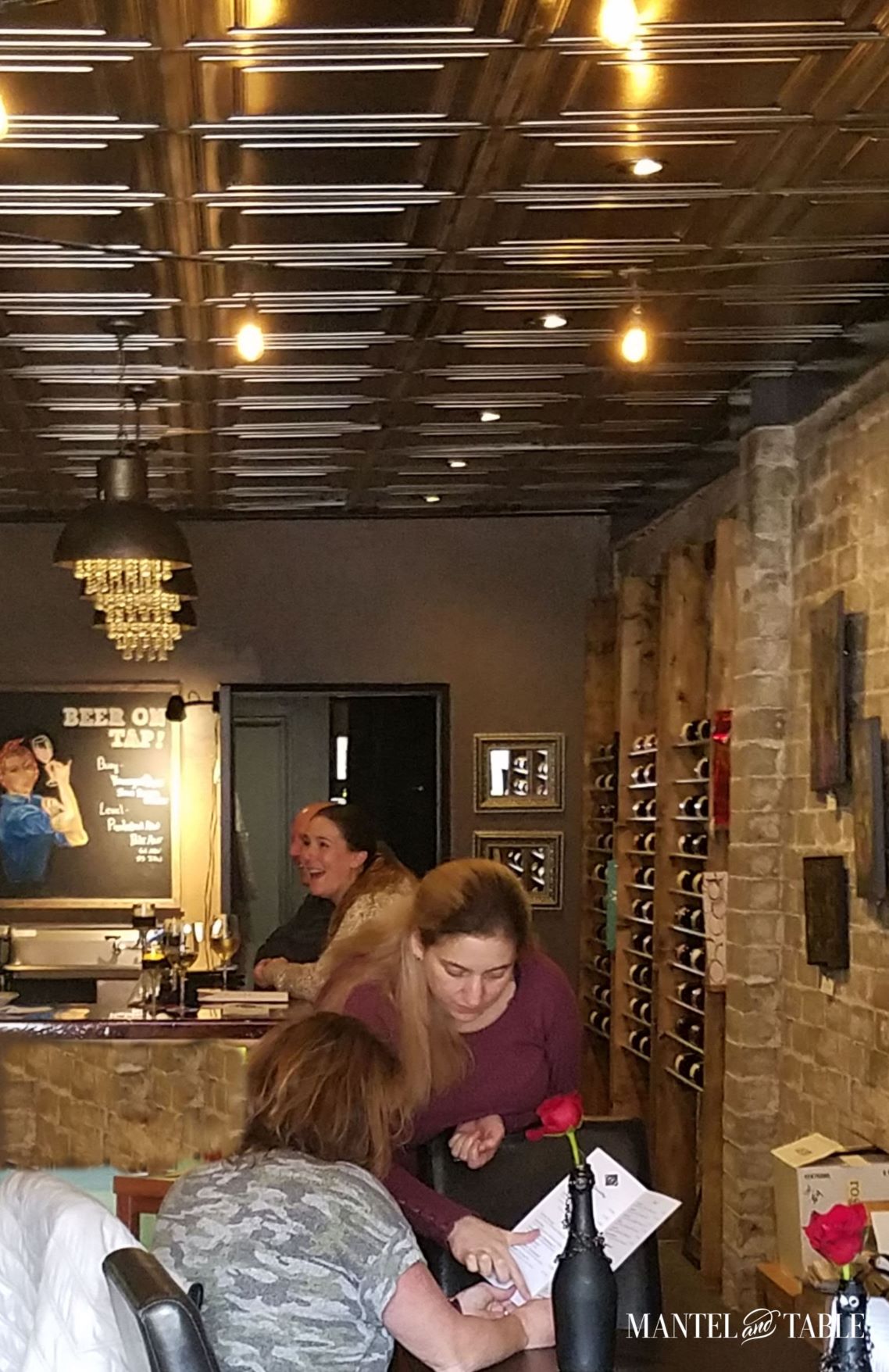 Brute Wine Bar Astoria OR ~ Long view into the bar, people laughing and looking at menus