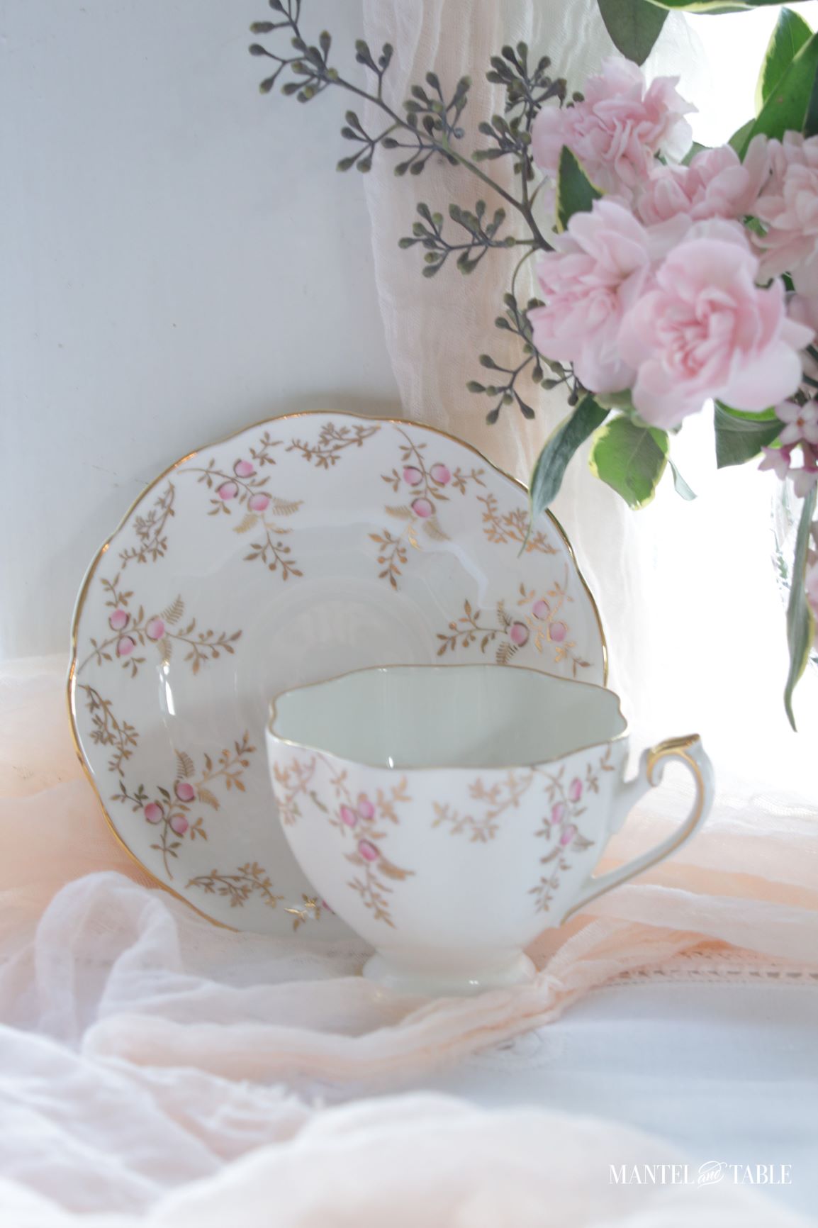 Teacup and saucer with pink flowers