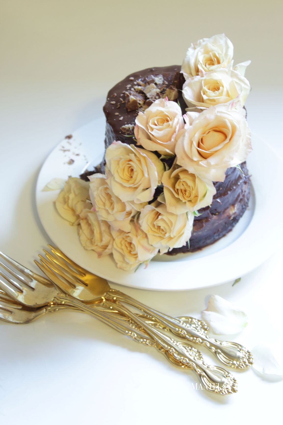 A tiny chocolate cake on a white surface