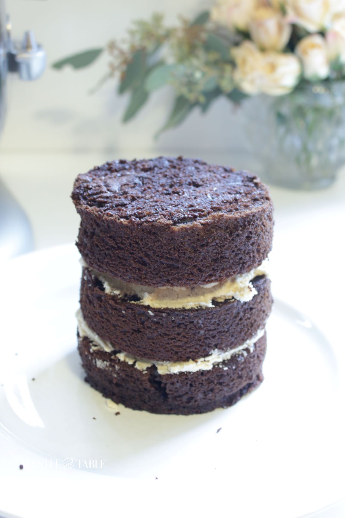 Three tiny cake layers stacked with frosting between