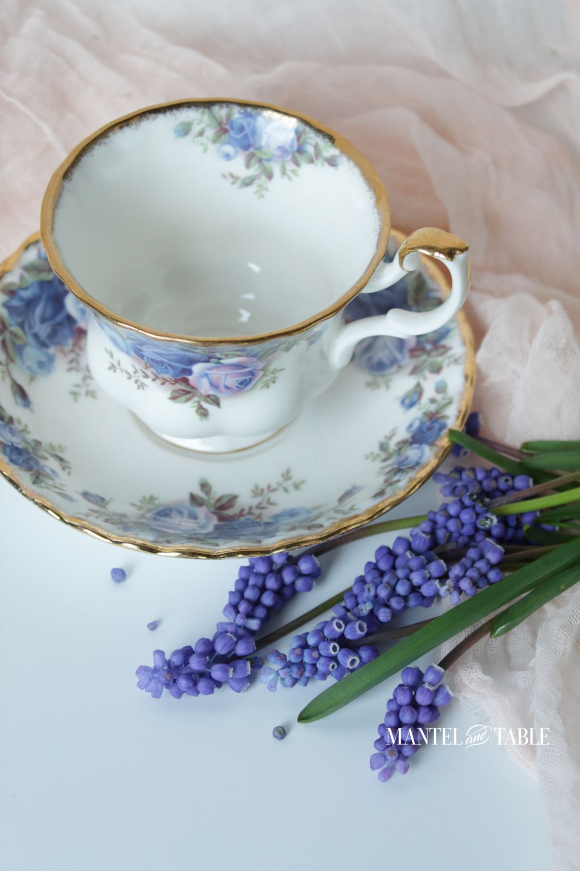 Royal Albert Moonlight Rose cup and saucer on pink voile with blue grape hyacinths