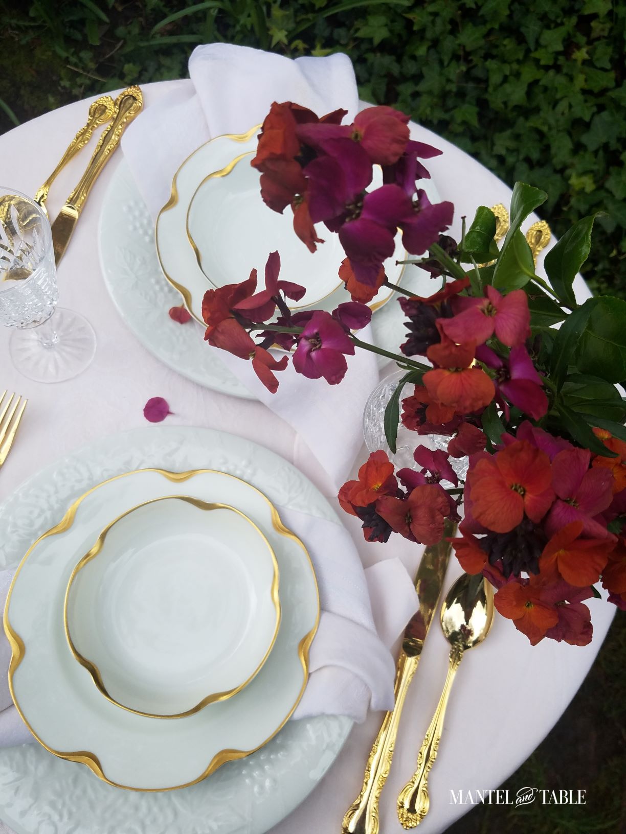 Pink table setting with bright burgundy flowers