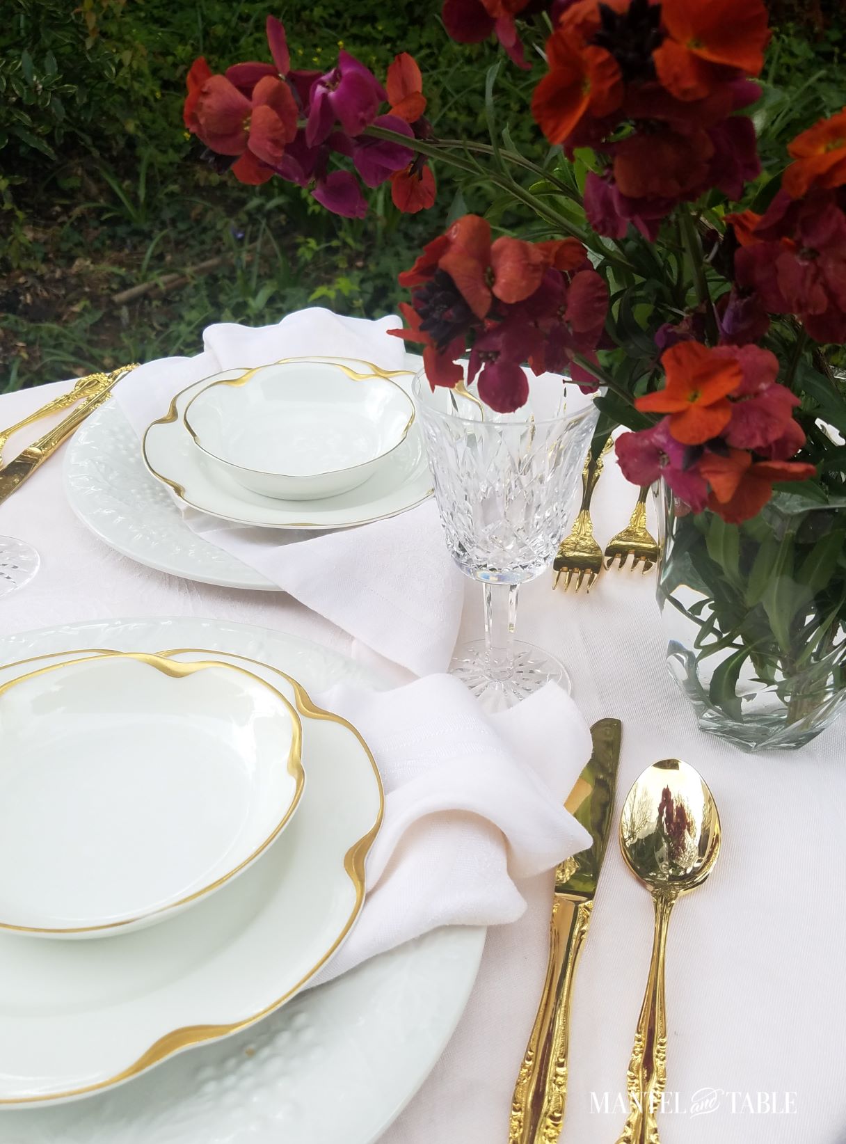Deep burgundy and orange flowers in a pink table setting