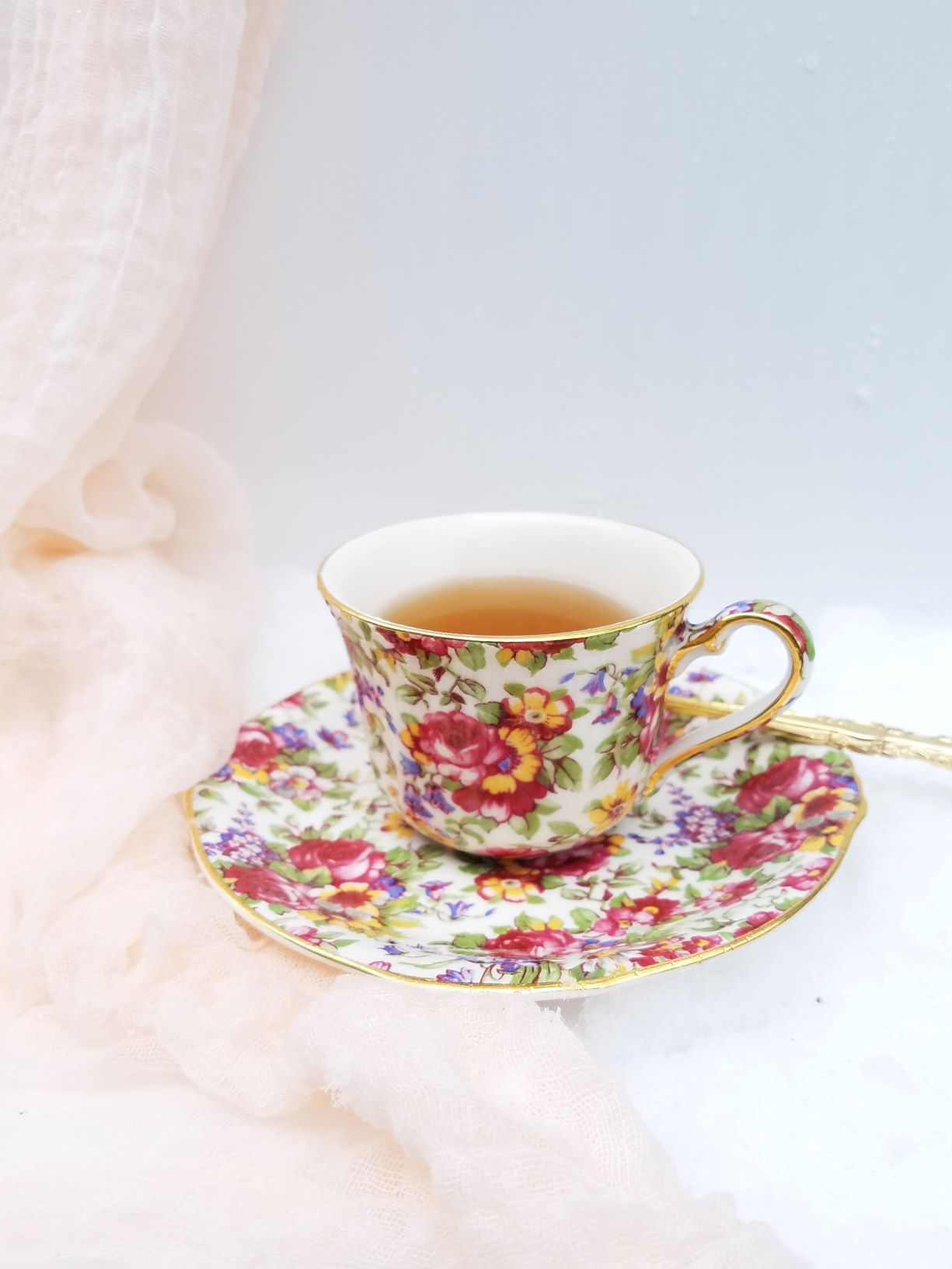 Bright chintz patterned teacup in the snow