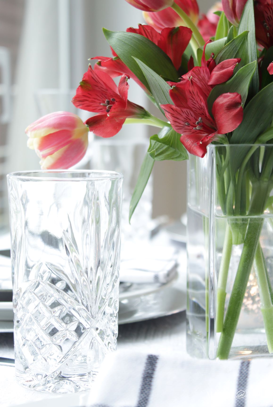 Elegant Spring Picnic tablescape crystal water glass & flowers