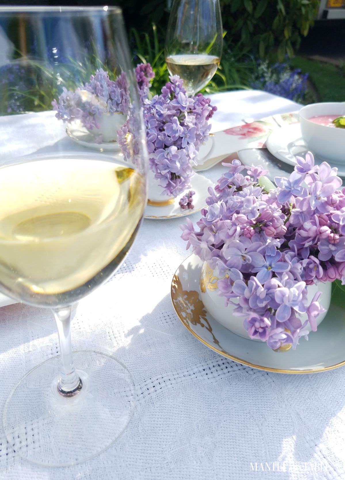 Glass of white wine on a set table.