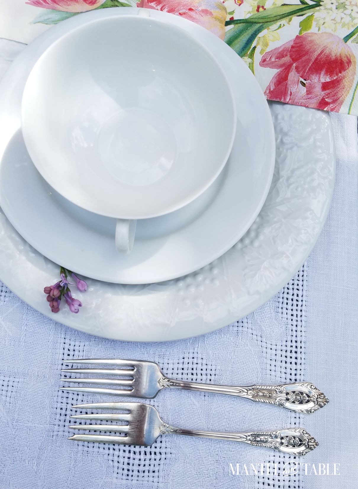 Bright spring tablescape ~ closeup of plate stack and silver
