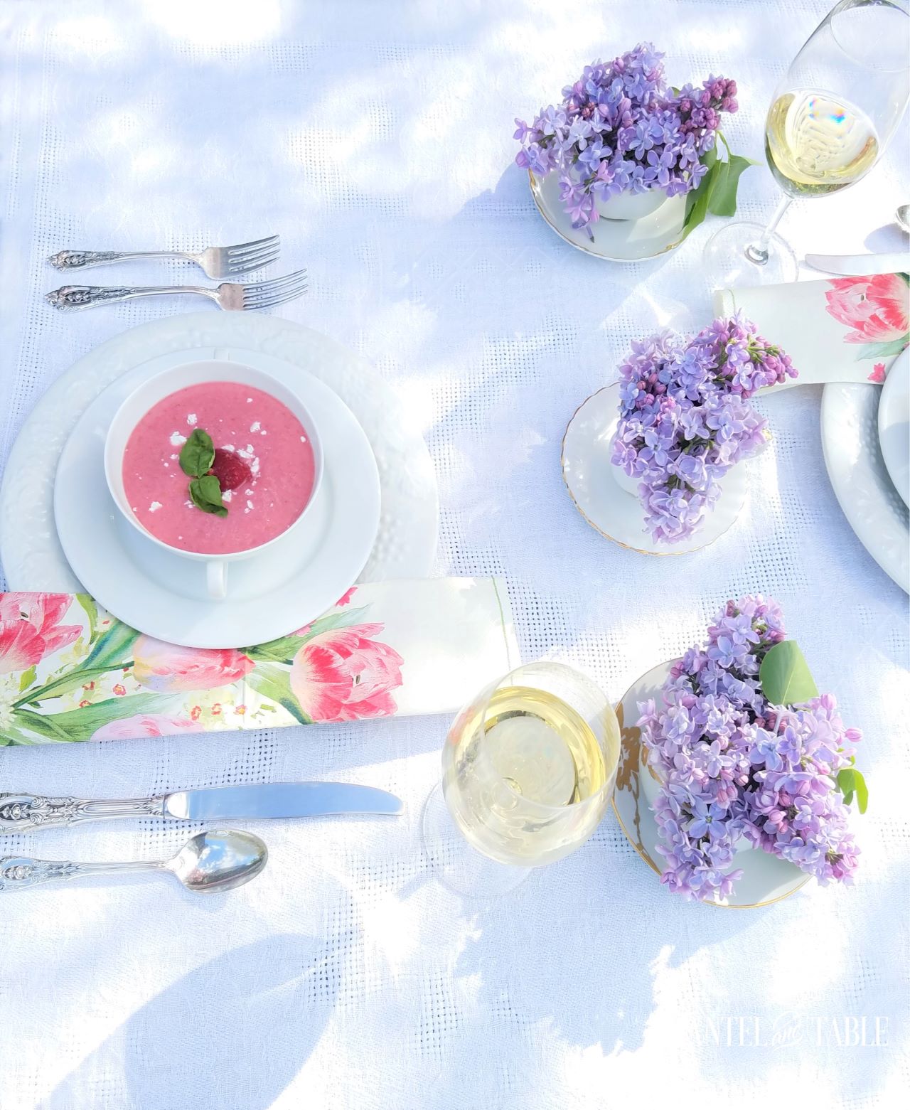 White tablescape with lilac centerpiece and pink soup
