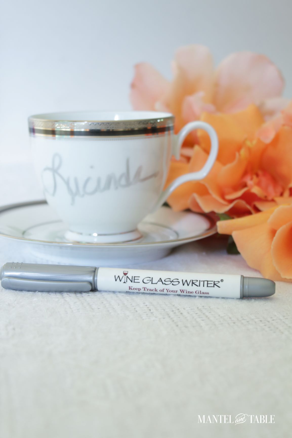 Closeup of teacup place card with Wine Glass Writer pen
