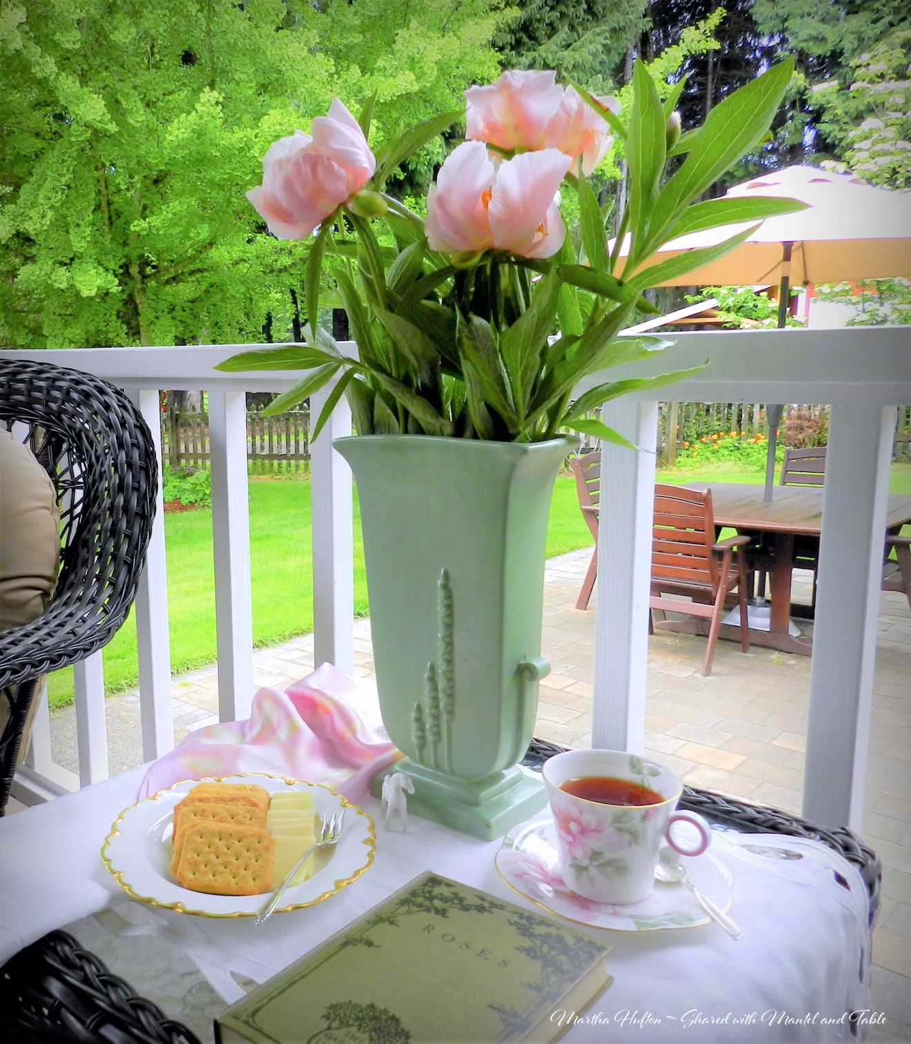 Tea table with vase of pink flowers