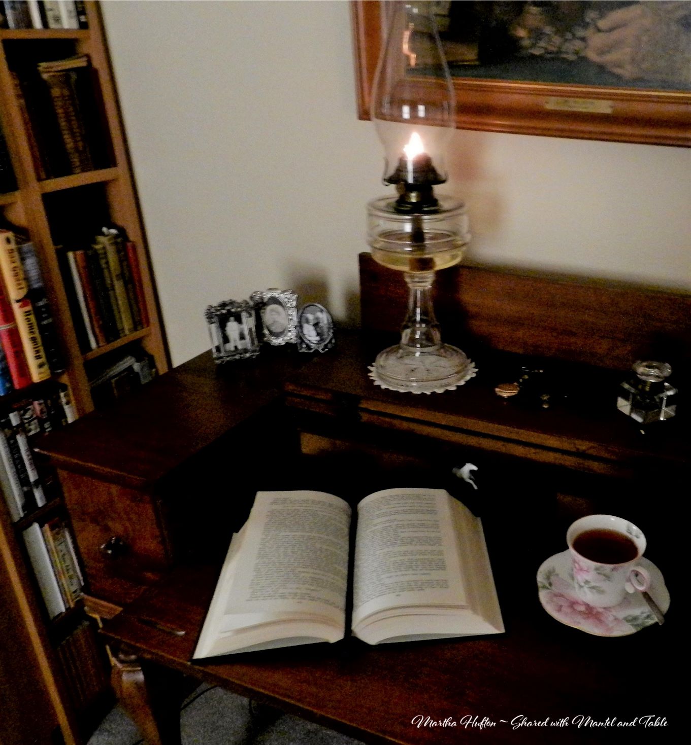 Teacup on desk with old fashioned oil lamp