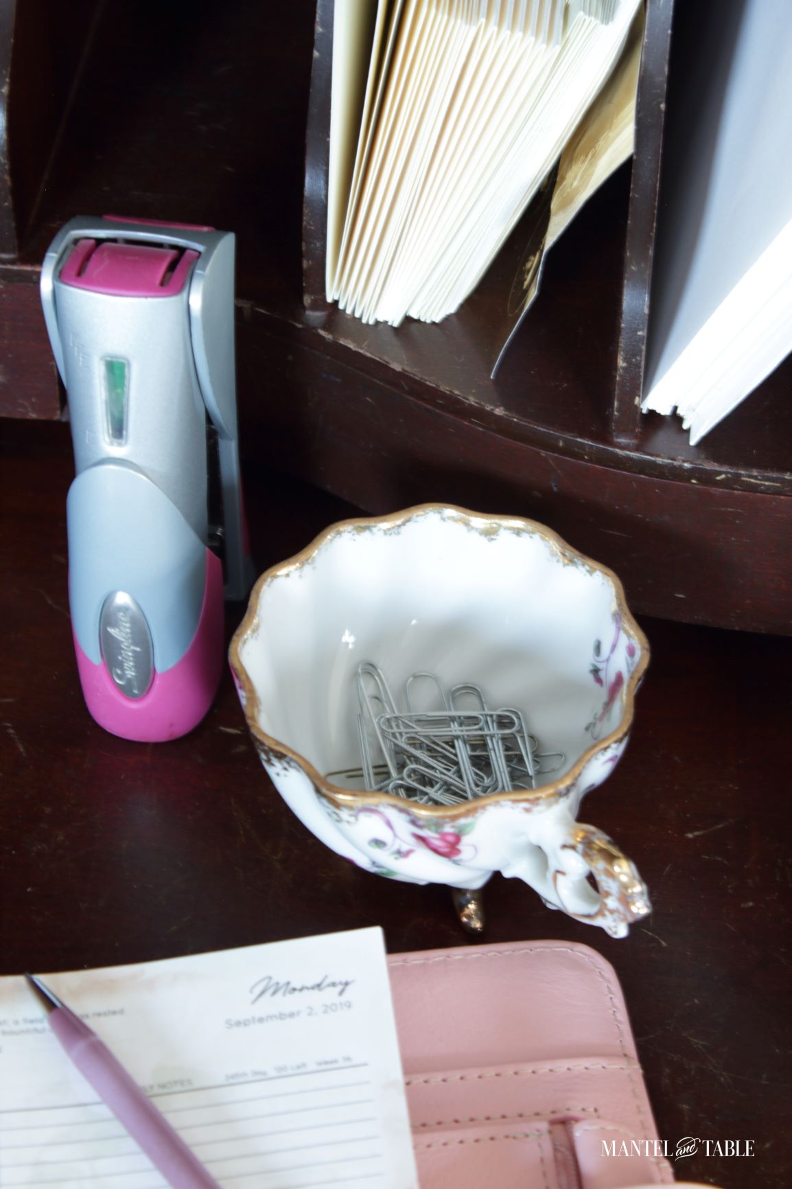 Teacup holding paperclips on desk